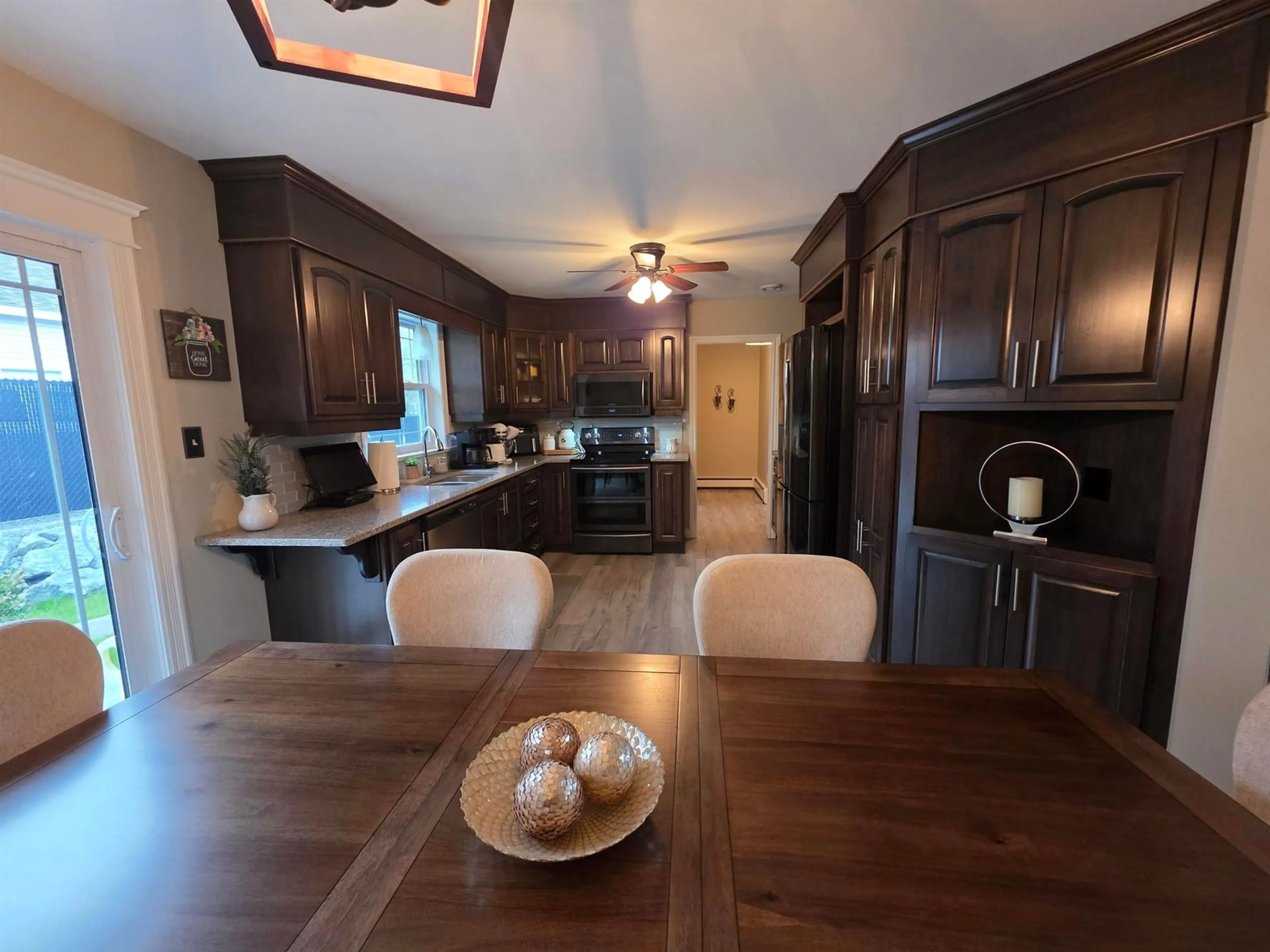 Open concept kitchen, wood/laminate floor for 44 Beaumont Ave, Sydney River Nova Scotia B1S 1J5
