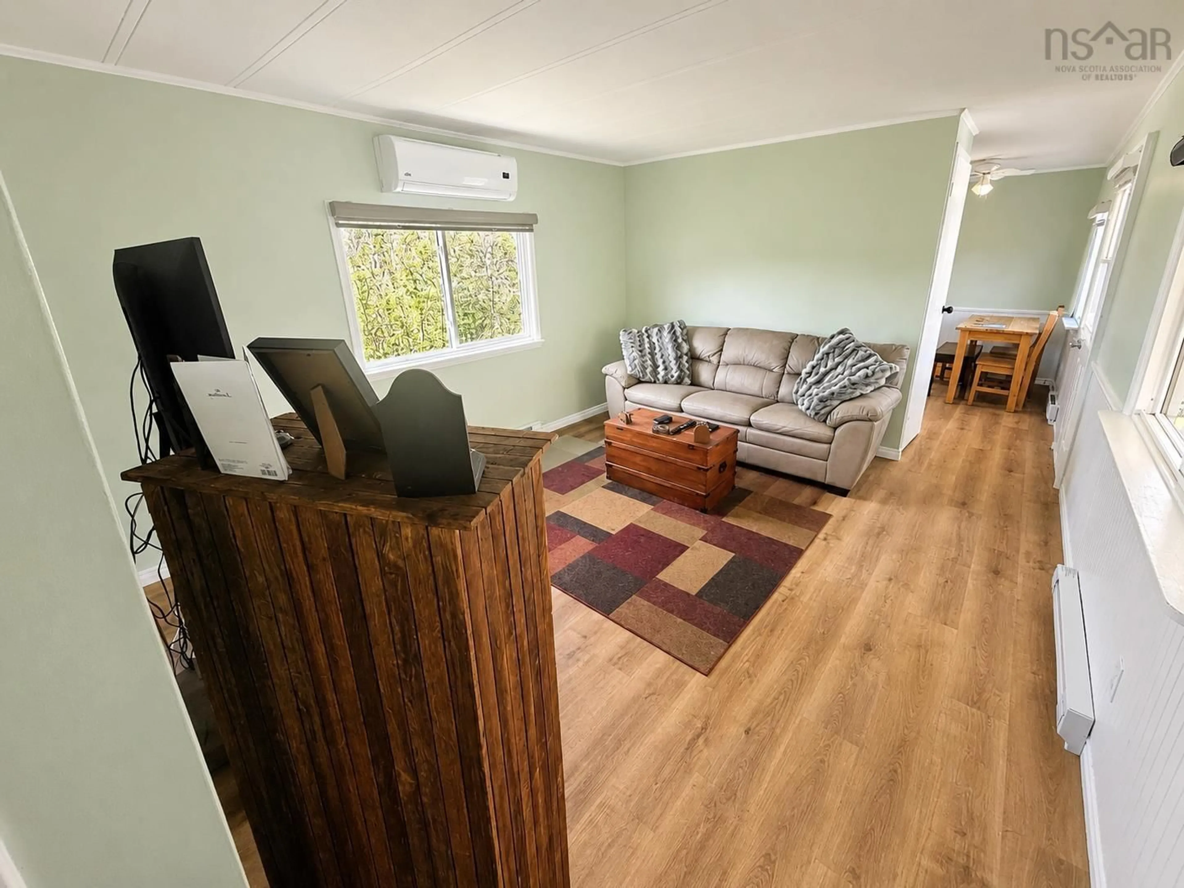 Living room with furniture, wood/laminate floor for 73 Old Post Rd, Barrington Nova Scotia B0W 1E0