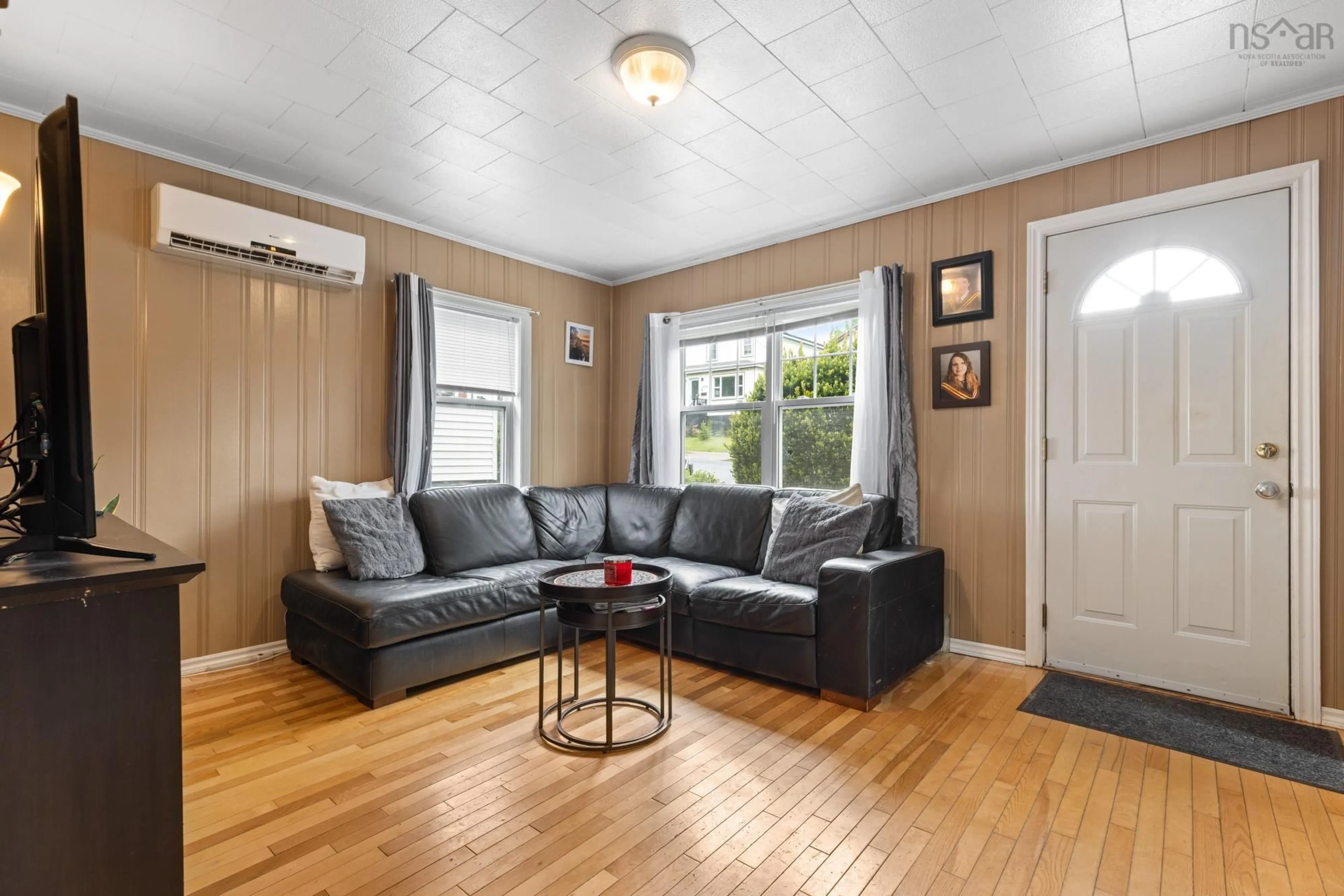 Living room with furniture, wood/laminate floor for 6091 Leeds St, North End Nova Scotia B3K 2T6