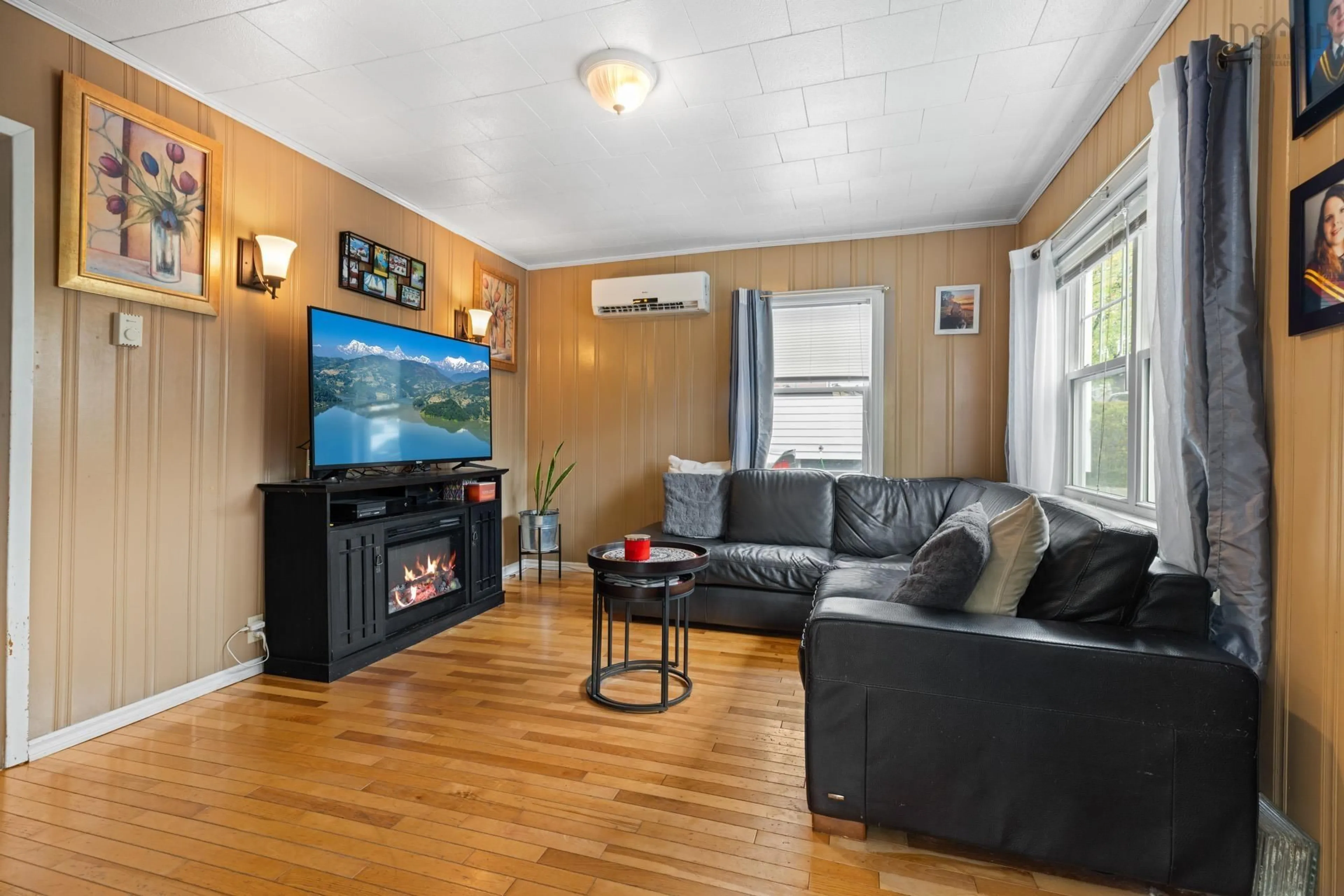 Living room with furniture, wood/laminate floor for 6091 Leeds St, North End Nova Scotia B3K 2T6