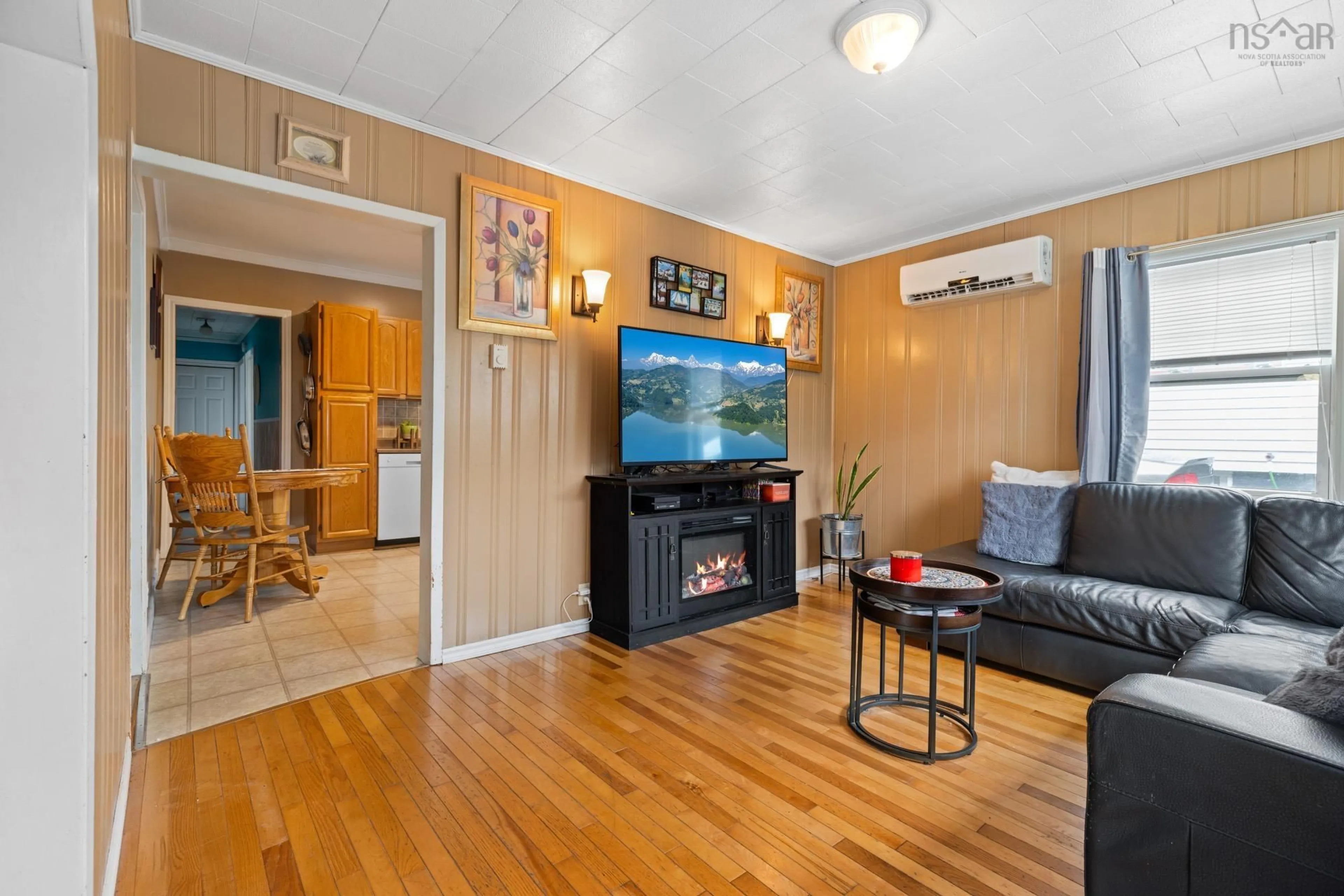 Living room with furniture, wood/laminate floor for 6091 Leeds St, North End Nova Scotia B3K 2T6
