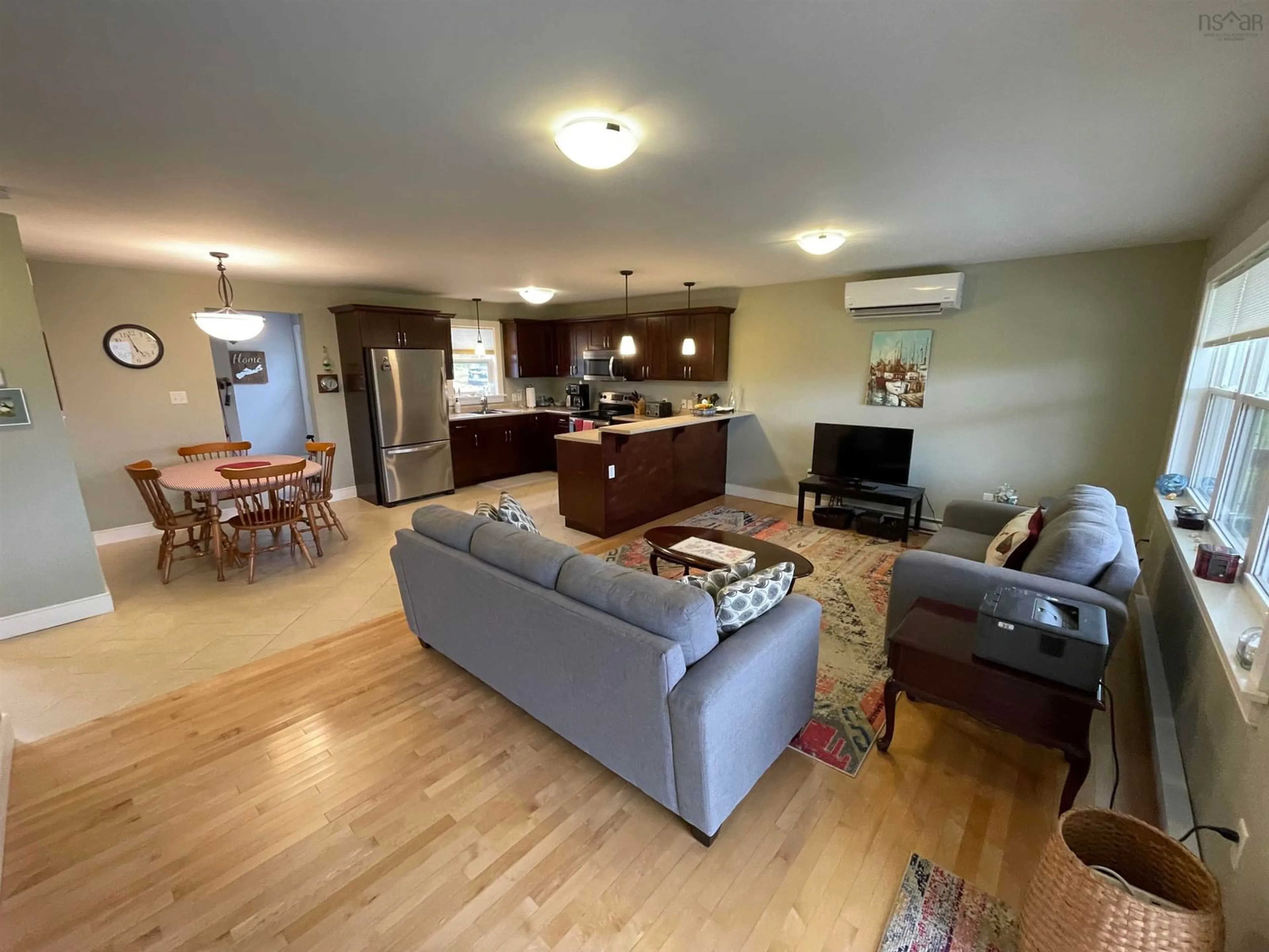 Living room with furniture, wood/laminate floor for 11599 Kempt Head Rd, Boularderie Centre Nova Scotia B1X 1K6