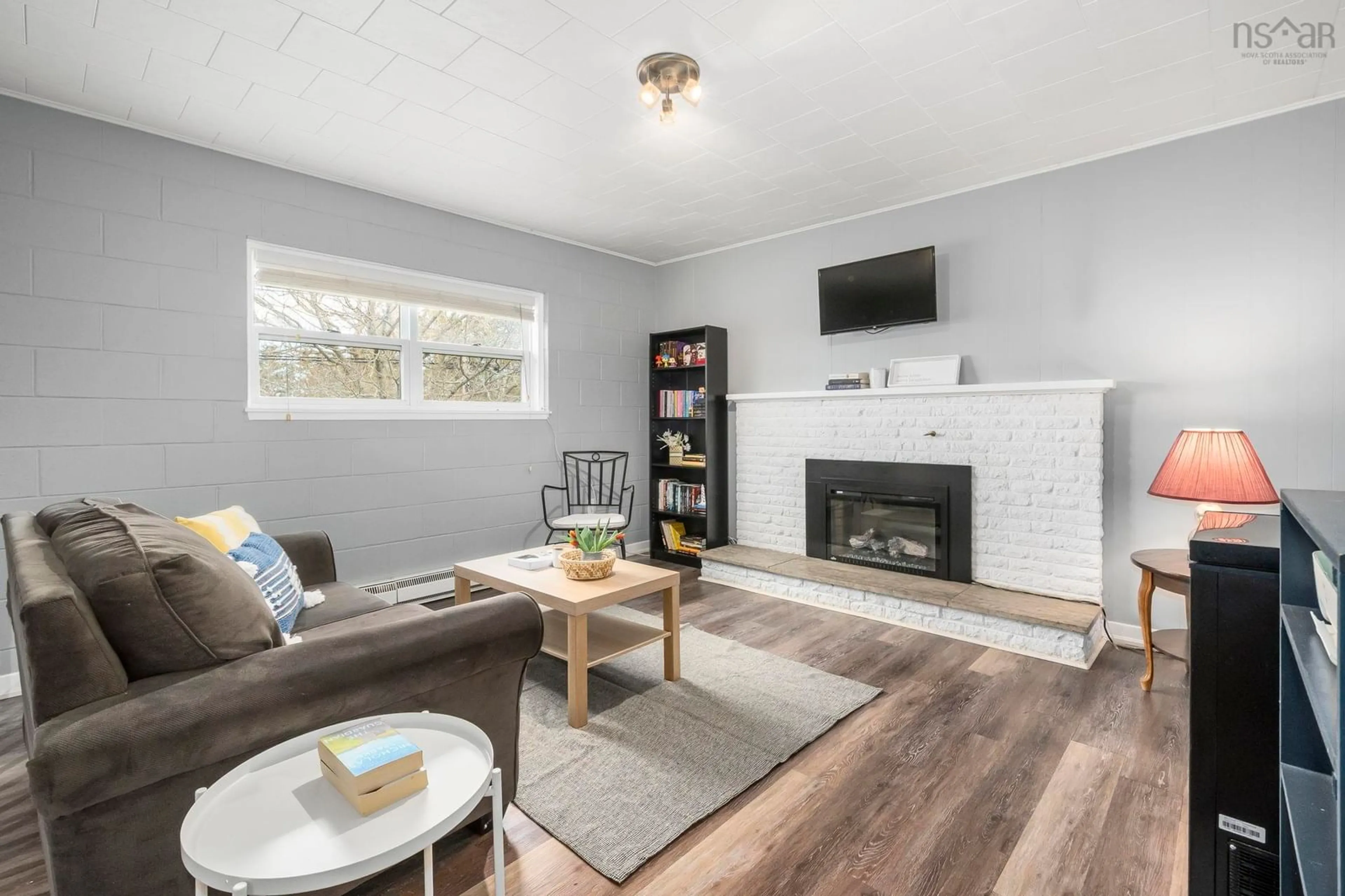 Living room with furniture, wood/laminate floor for 73/75 Pleasant St, Wolfville Nova Scotia B4P 2R7