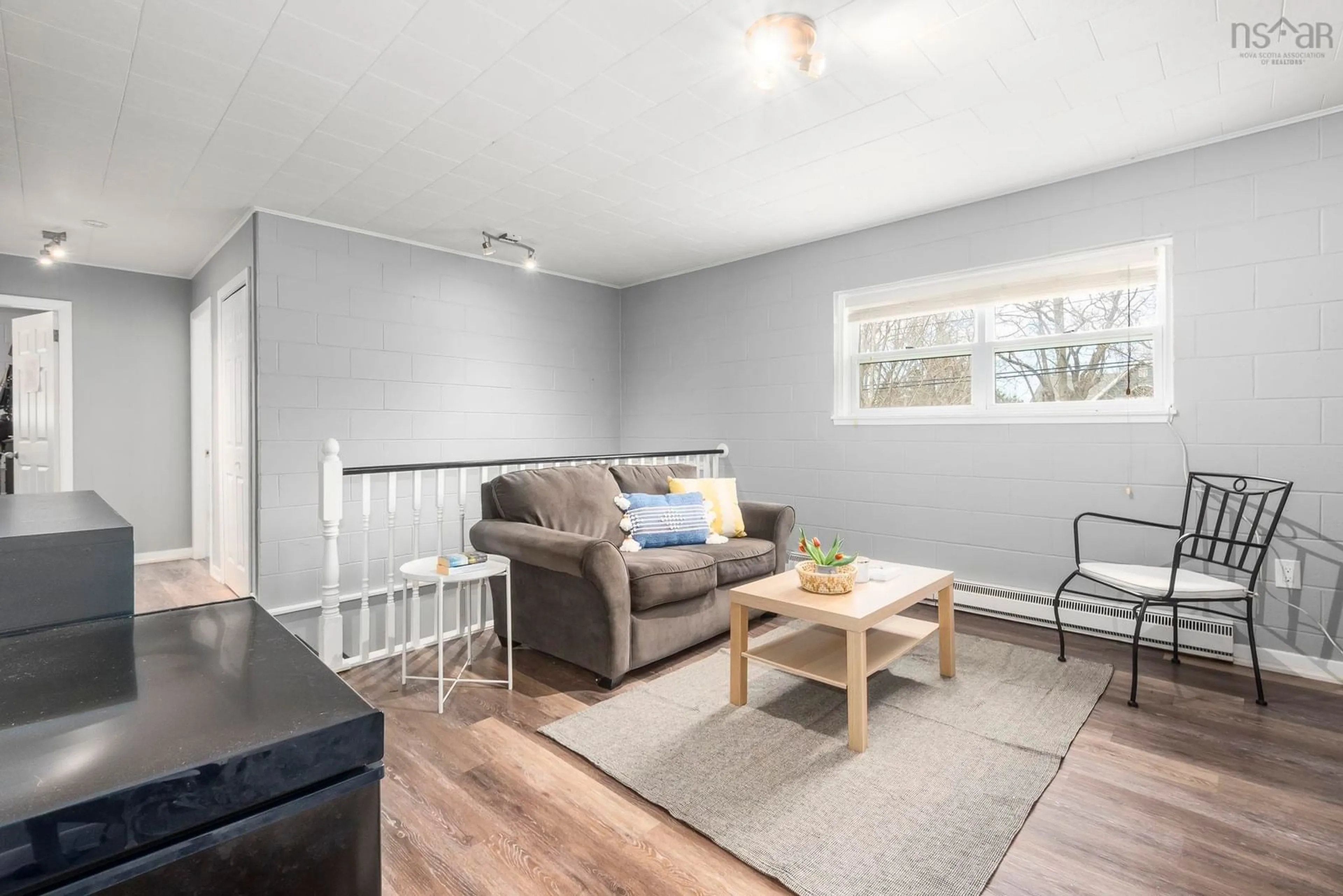 Living room with furniture, wood/laminate floor for 73/75 Pleasant St, Wolfville Nova Scotia B4P 2R7