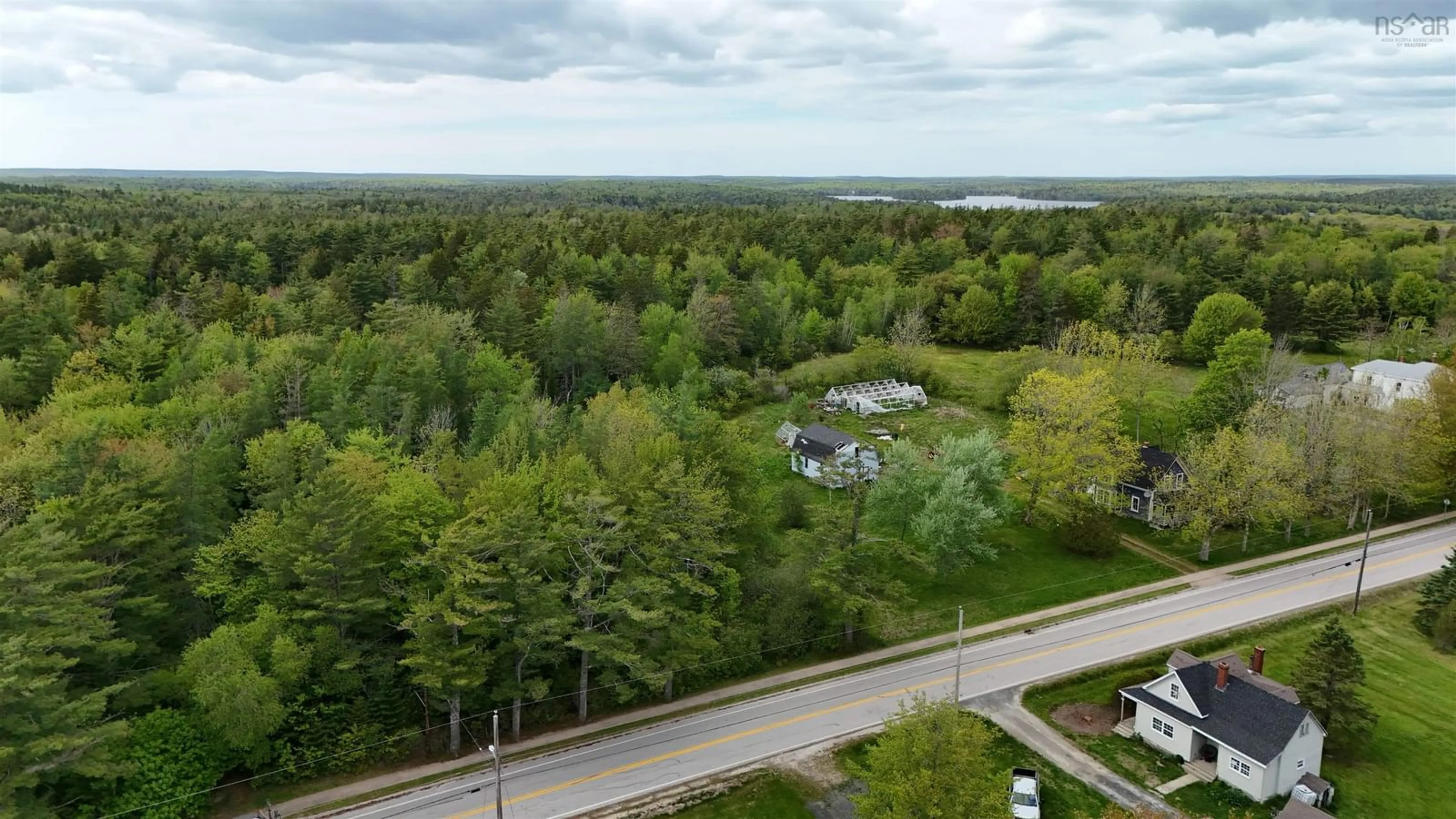 A pic from outside/outdoor area/front of a property/back of a property/a pic from drone, water/lake/river/ocean view for 2091 Highway 203, Kemptville Nova Scotia B5A 5P4