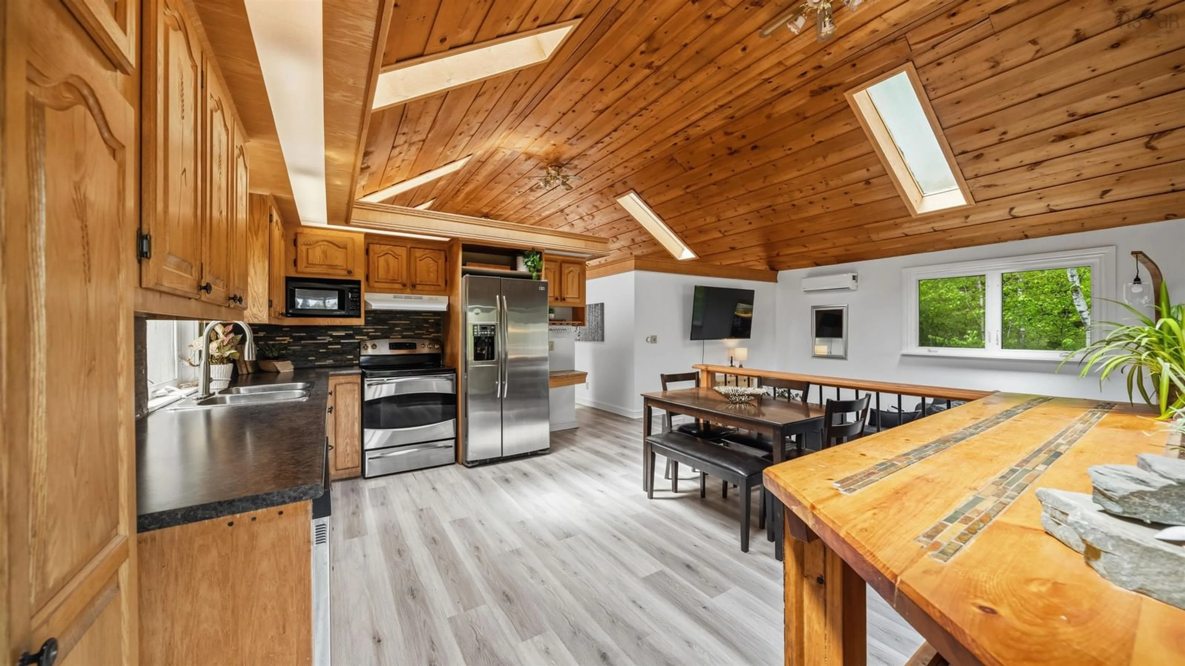Open concept kitchen, wood/laminate floor for 832 Myra Rd, Porters Lake Nova Scotia B3E 1G5