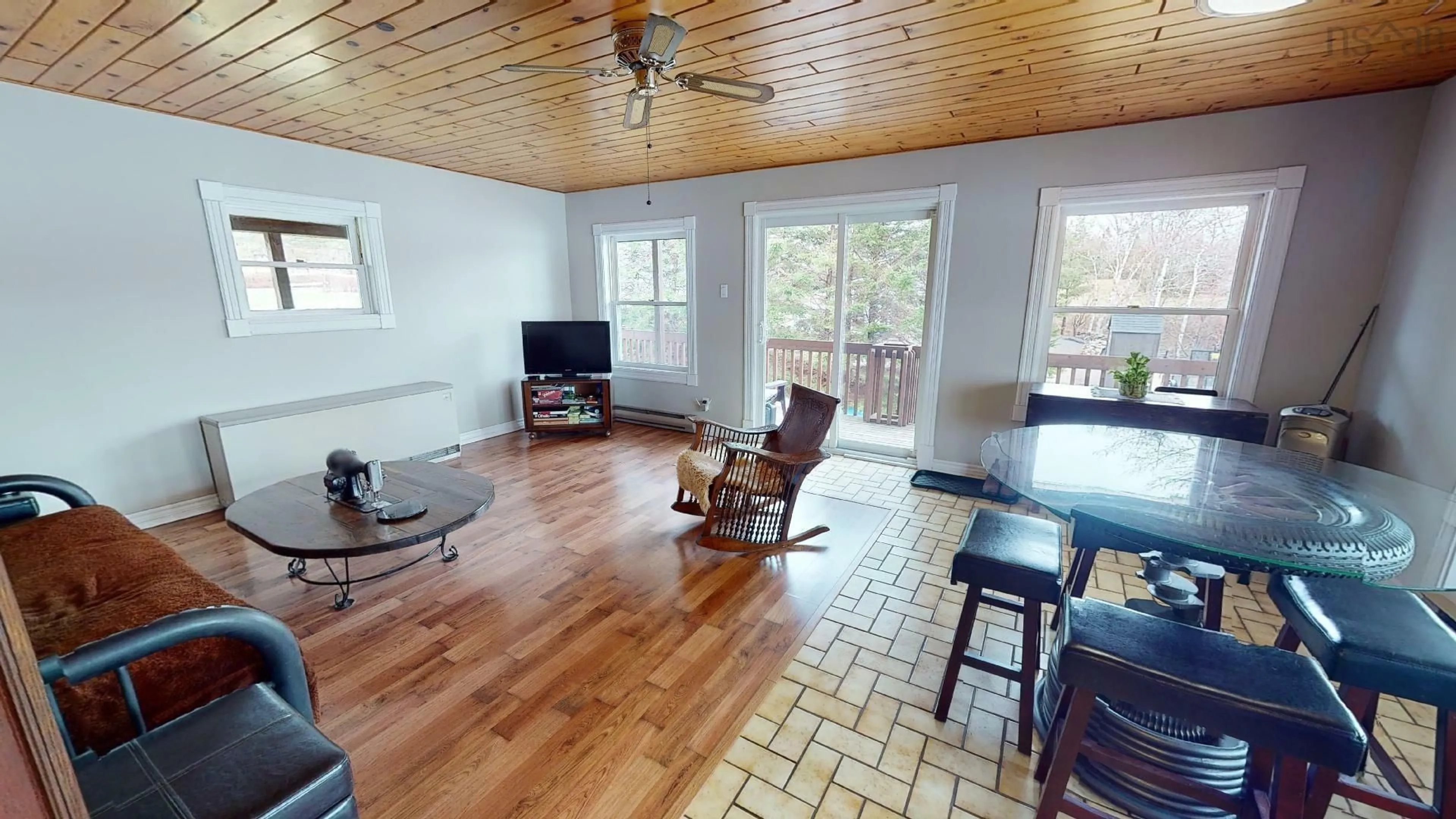 Living room with furniture, wood/laminate floor for 13249 Nova Scotia 7 Hwy, Aspen Nova Scotia B0H 1E0