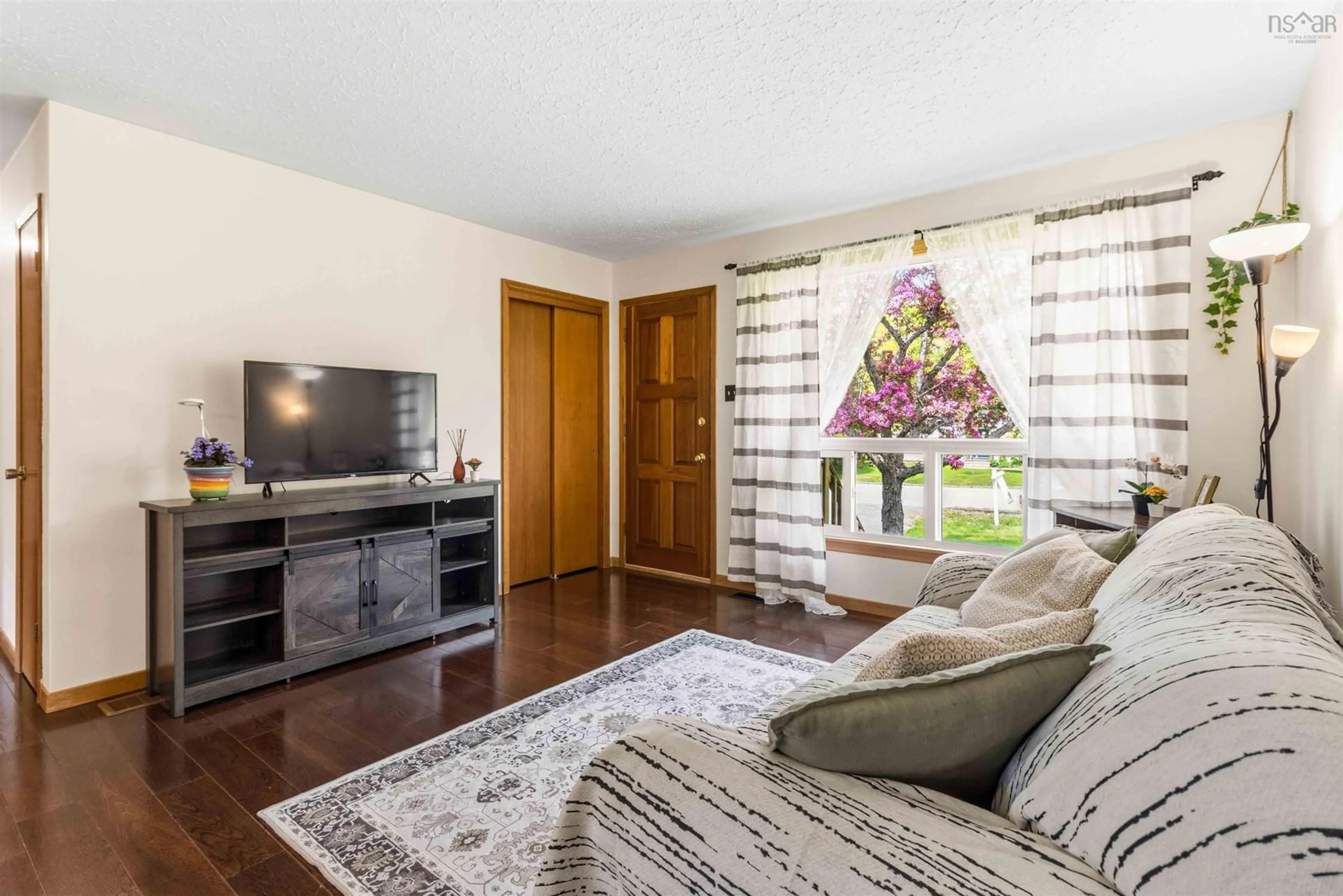 Living room with furniture, wood/laminate floor for 77 Carleton Dr, Lake Echo Nova Scotia B3E 1A1