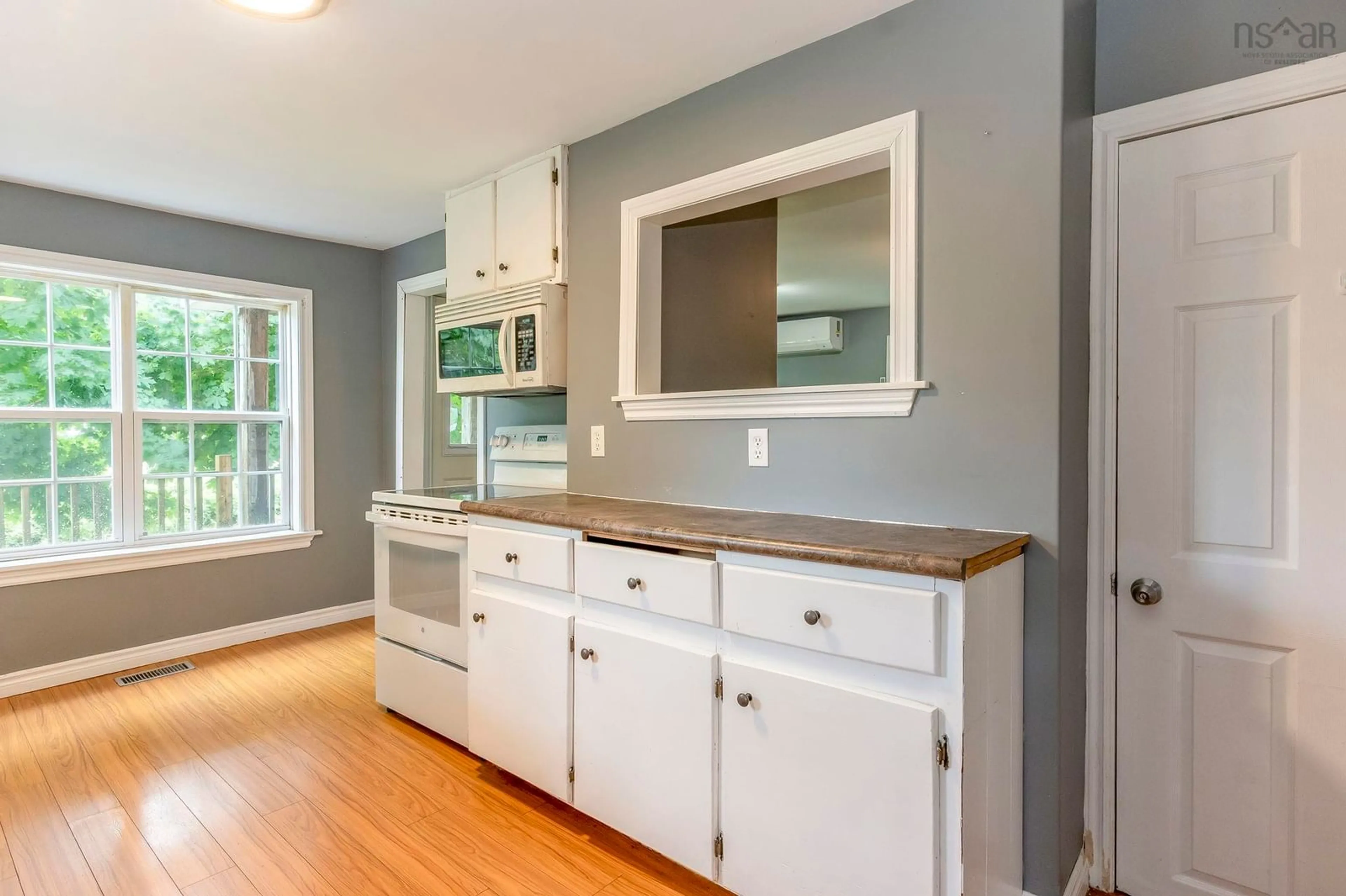 Open concept kitchen, wood/laminate floor for 623 Main St, Lawrencetown Nova Scotia B0S 1M0