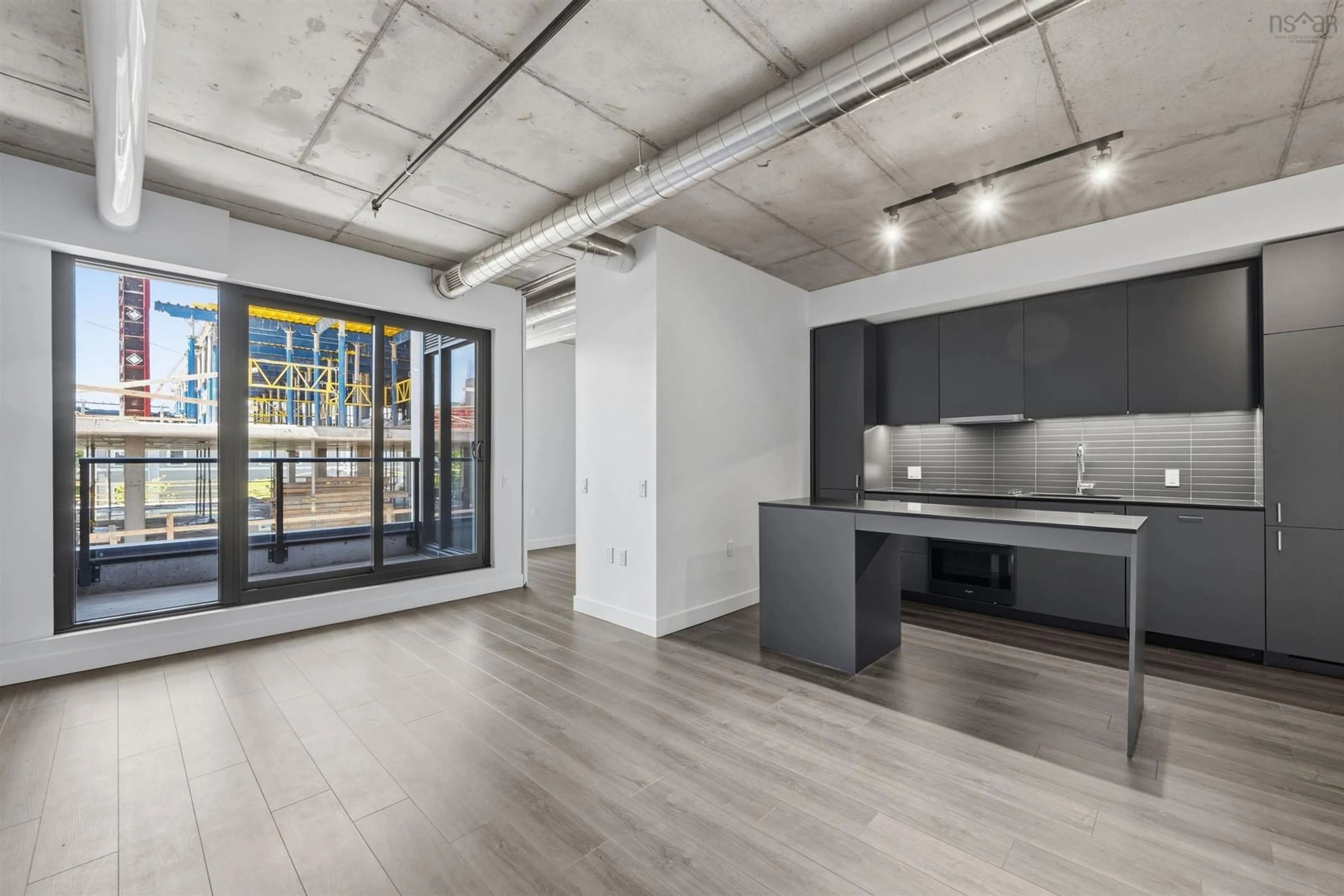 Open concept kitchen, cement floor for 5511 Bilby St #307, Halifax Nova Scotia B3K 0M5