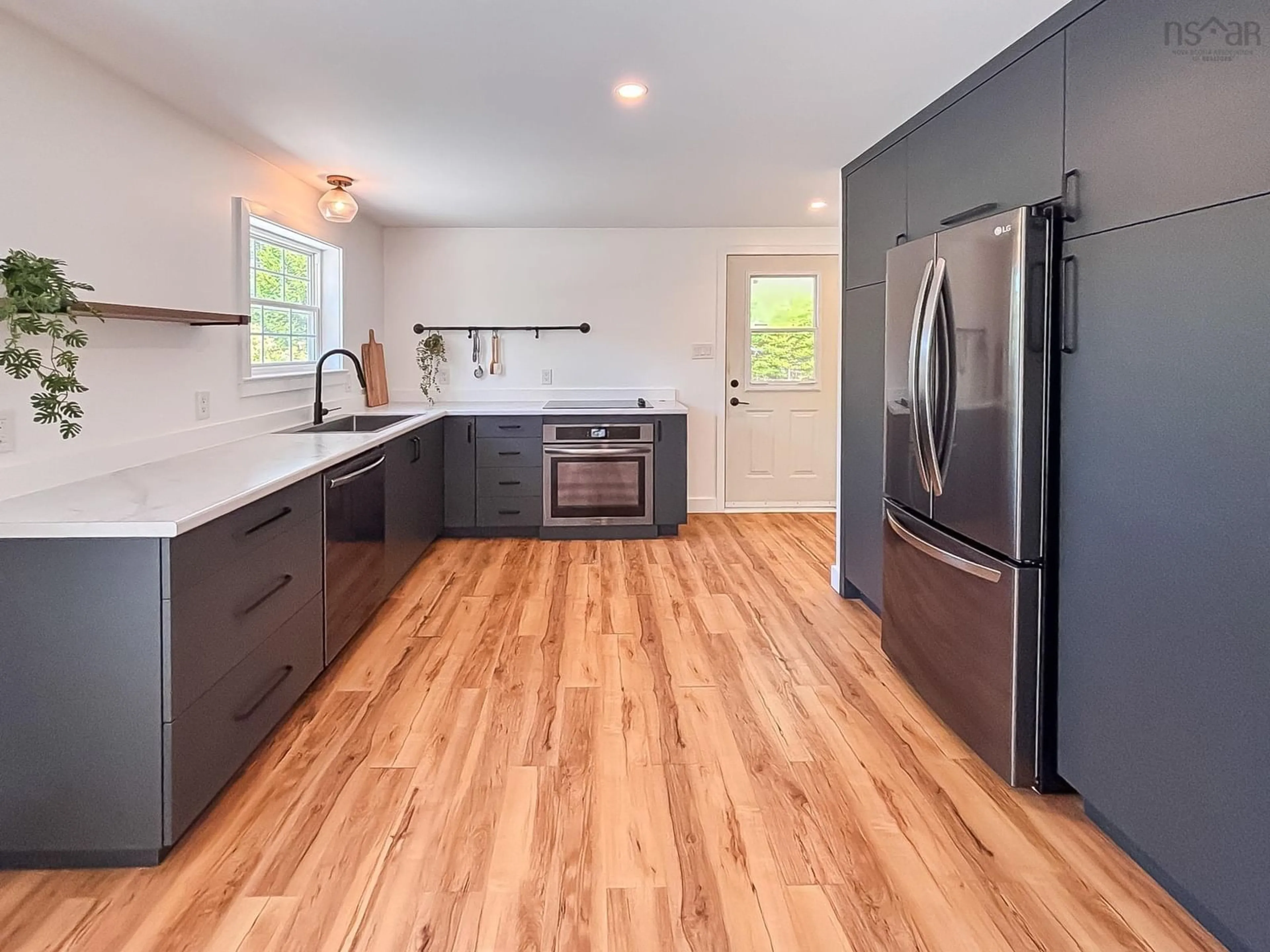 Open concept kitchen, wood/laminate floor for 7822 Highway 3, Martins River Nova Scotia B0J 2E0