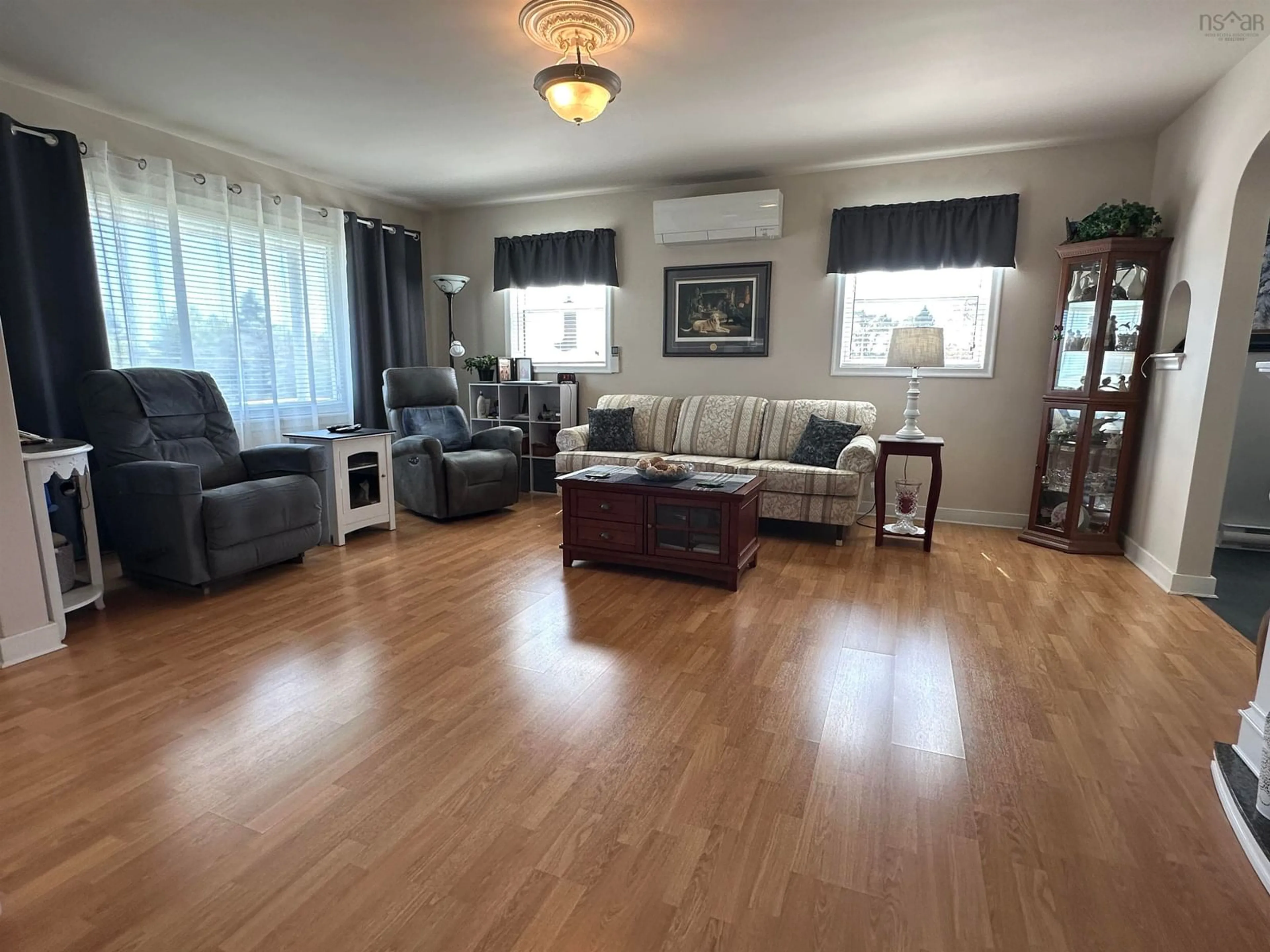 Living room with furniture, wood/laminate floor for 6670 Highway 3, Hunts Point Nova Scotia B0T 1G0