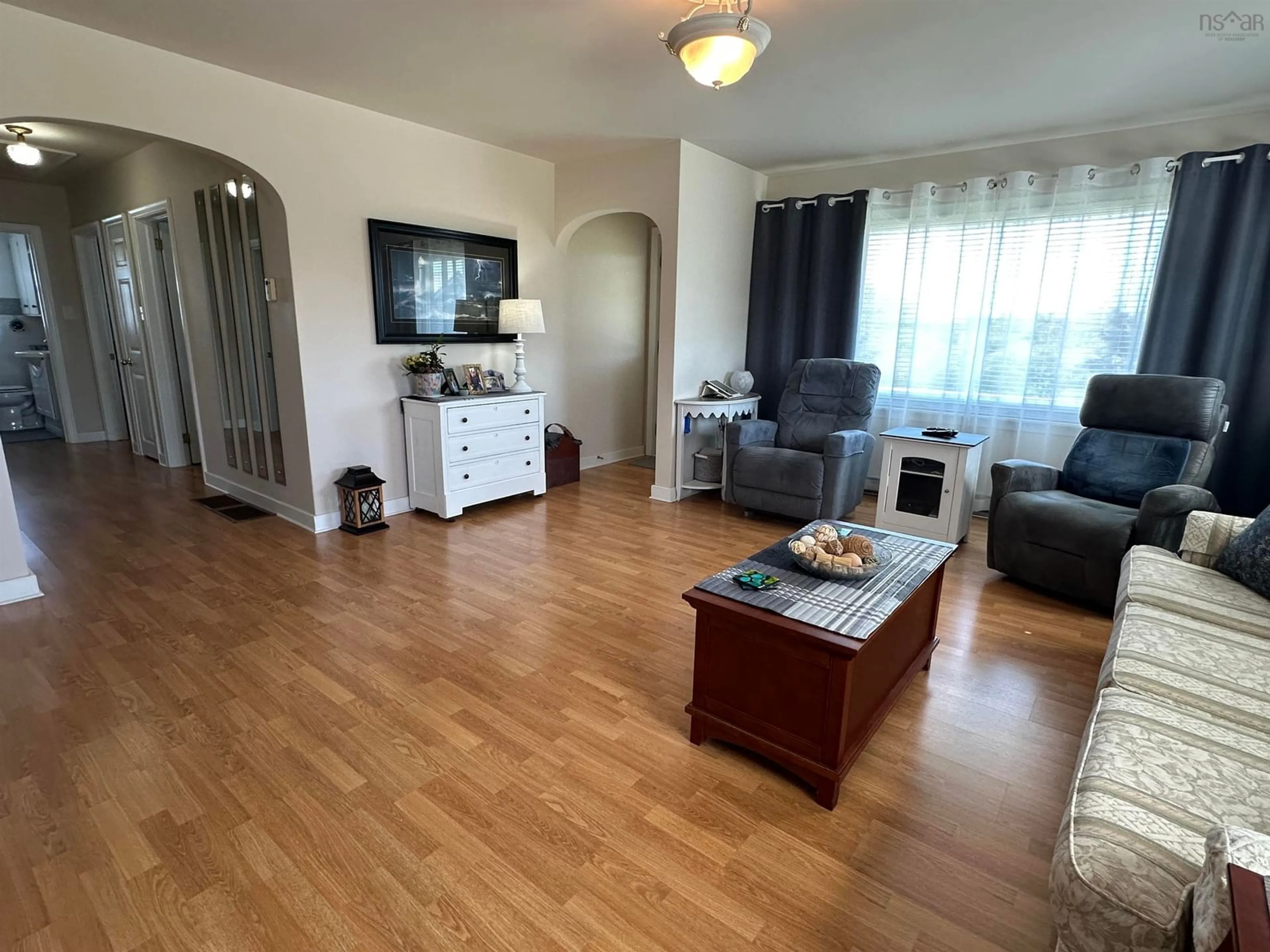 Living room with furniture, wood/laminate floor for 6670 Highway 3, Hunts Point Nova Scotia B0T 1G0