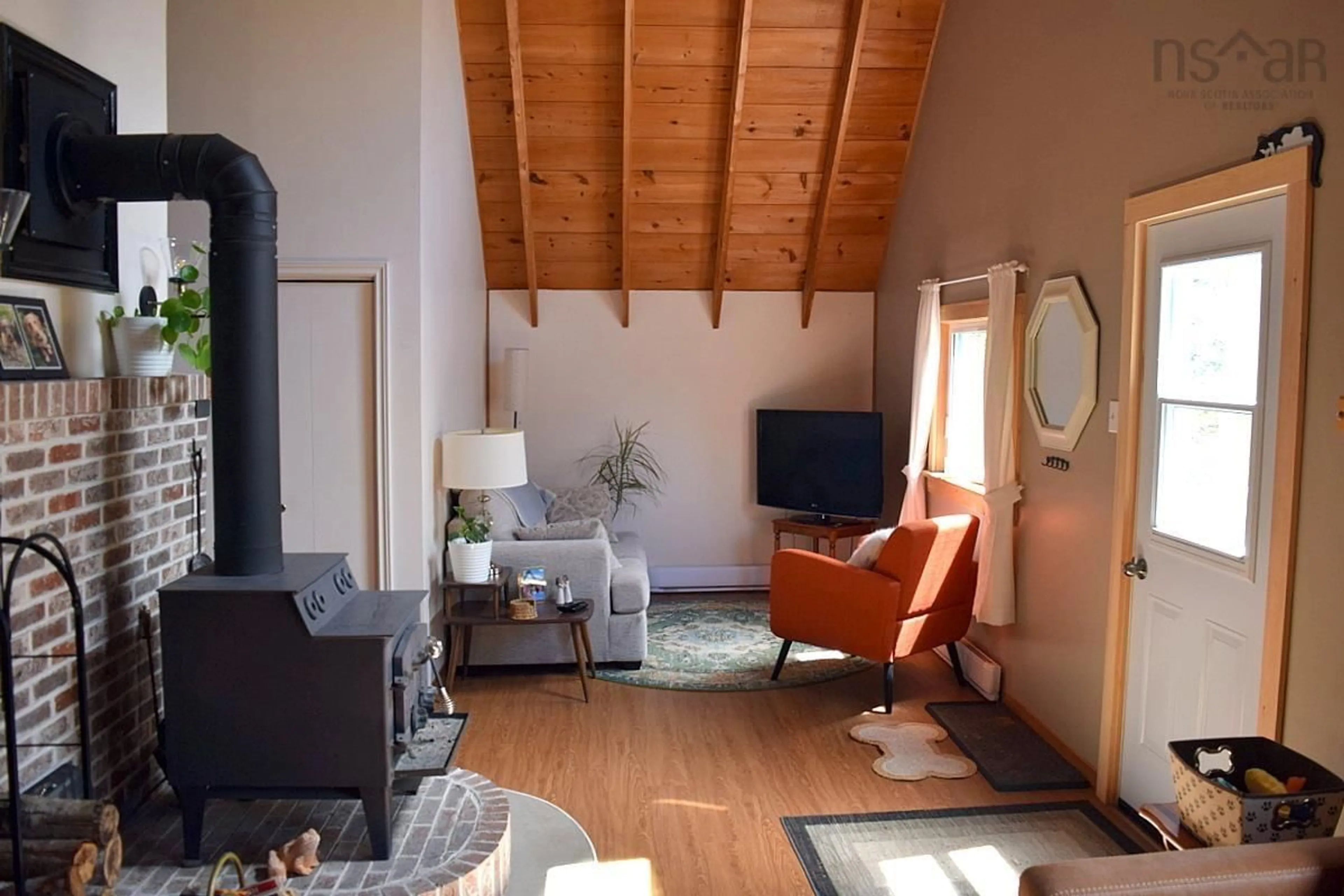 Living room with furniture, wood/laminate floor for 724 Smithville Rd, Mabou Nova Scotia B0E 1X0