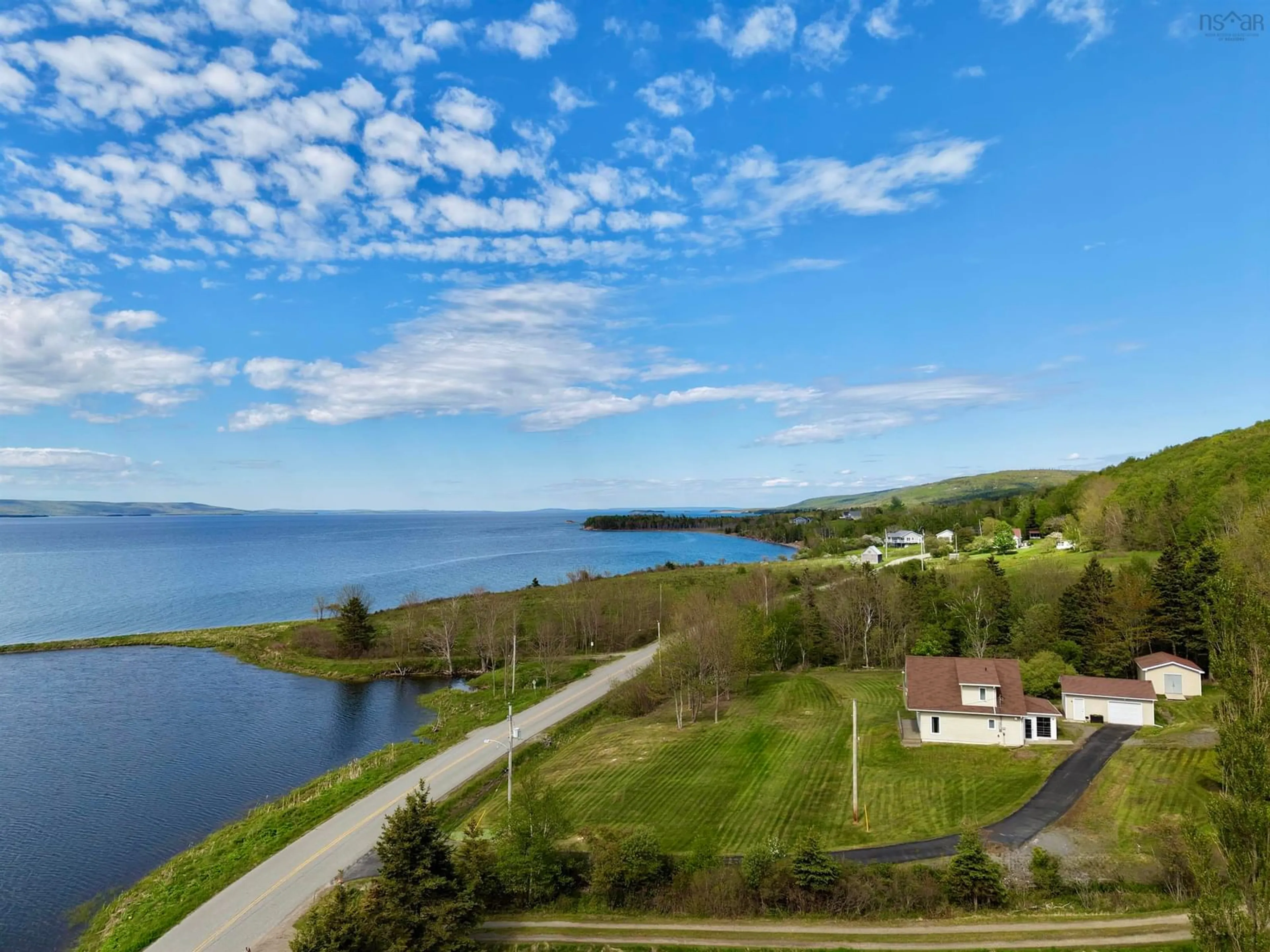 A pic from outside/outdoor area/front of a property/back of a property/a pic from drone, water/lake/river/ocean view for 3200 West Bay Rd., St George's Channel Nova Scotia B0E 3K0