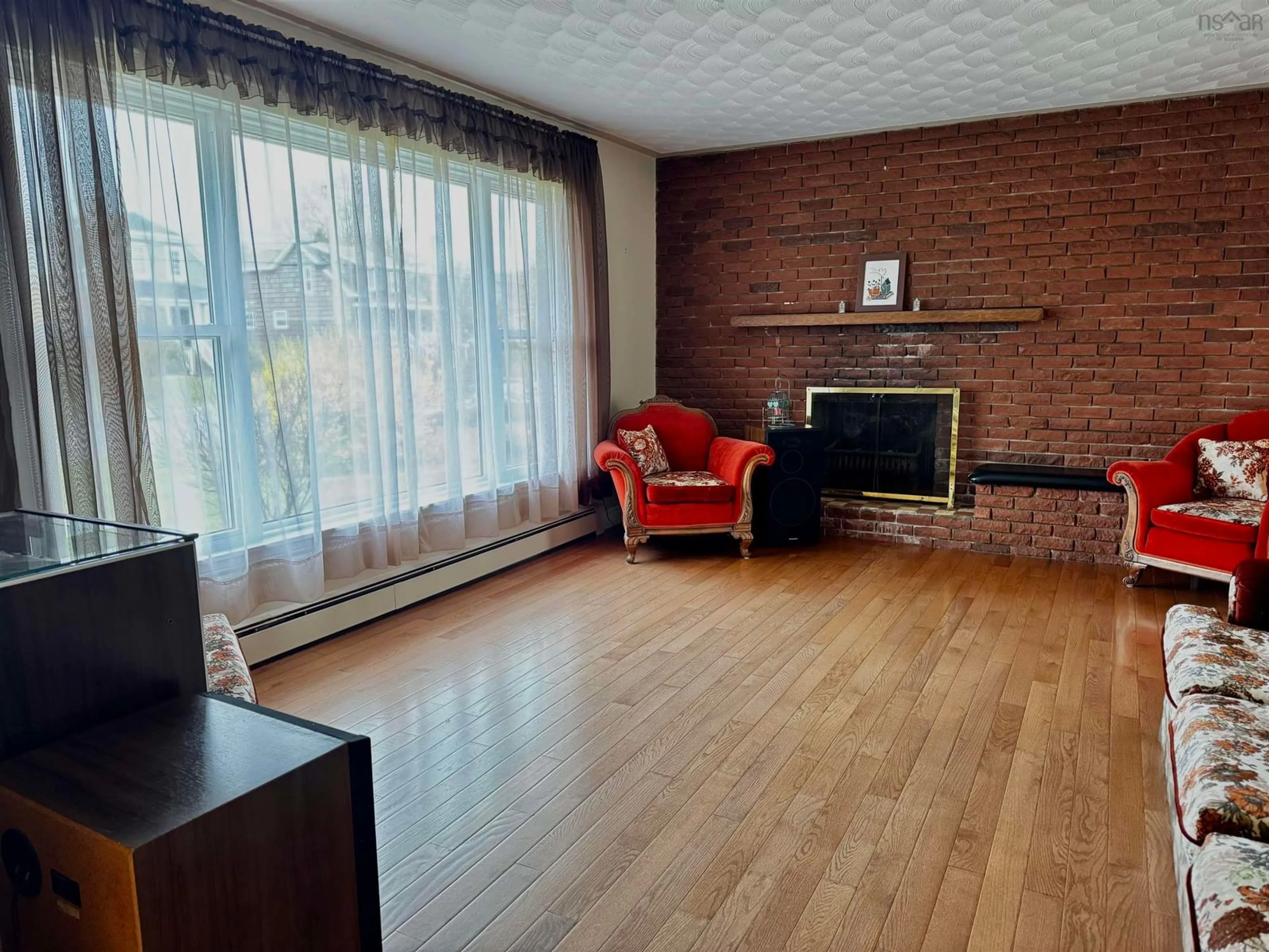 Living room with furniture, wood/laminate floor for 4 Macaulay Ave, Glace Bay Nova Scotia B1A 1C9