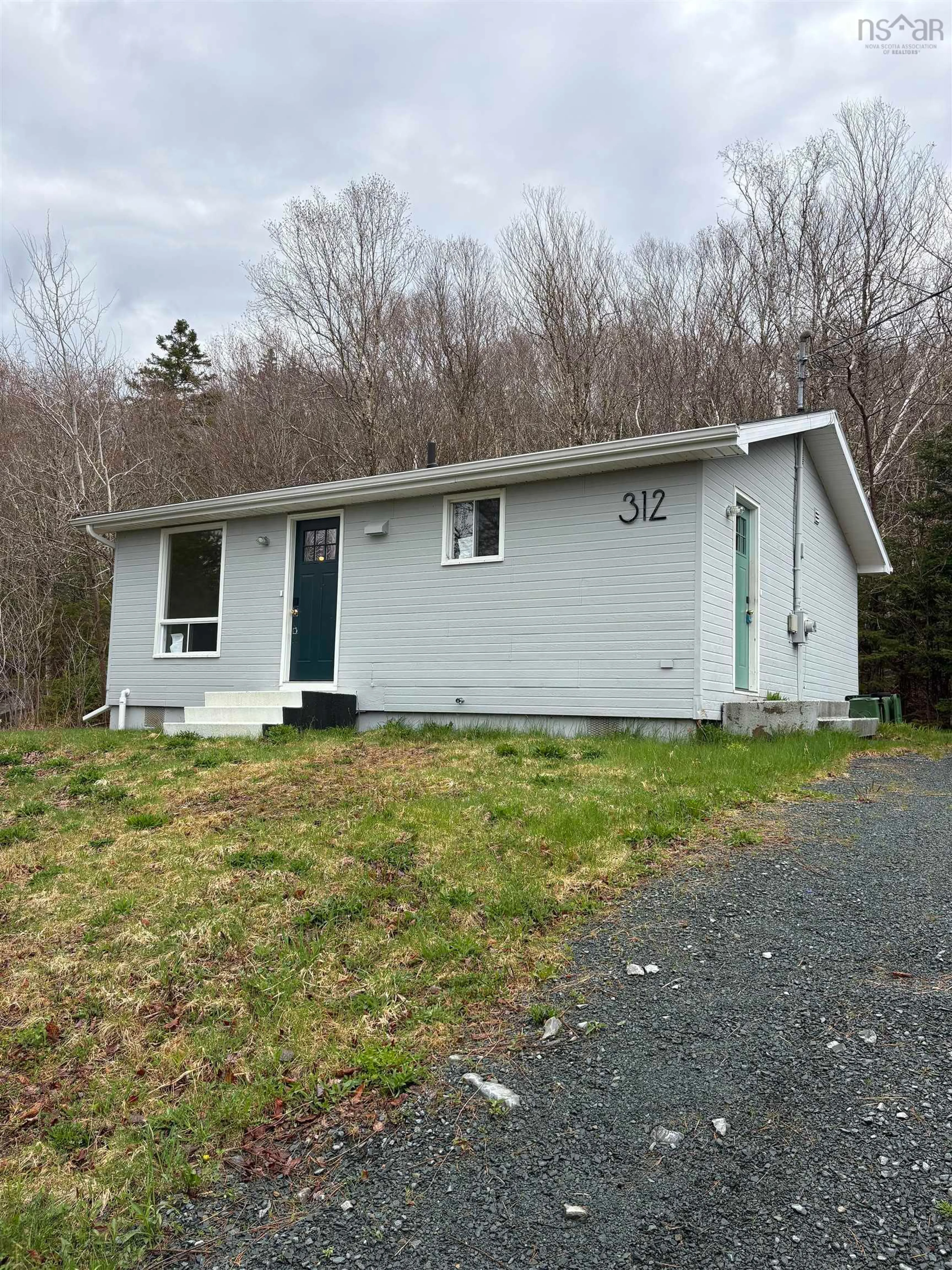 Home with vinyl exterior material, street for 312 East River Rd, Sheet Harbour Nova Scotia B0J 3B0