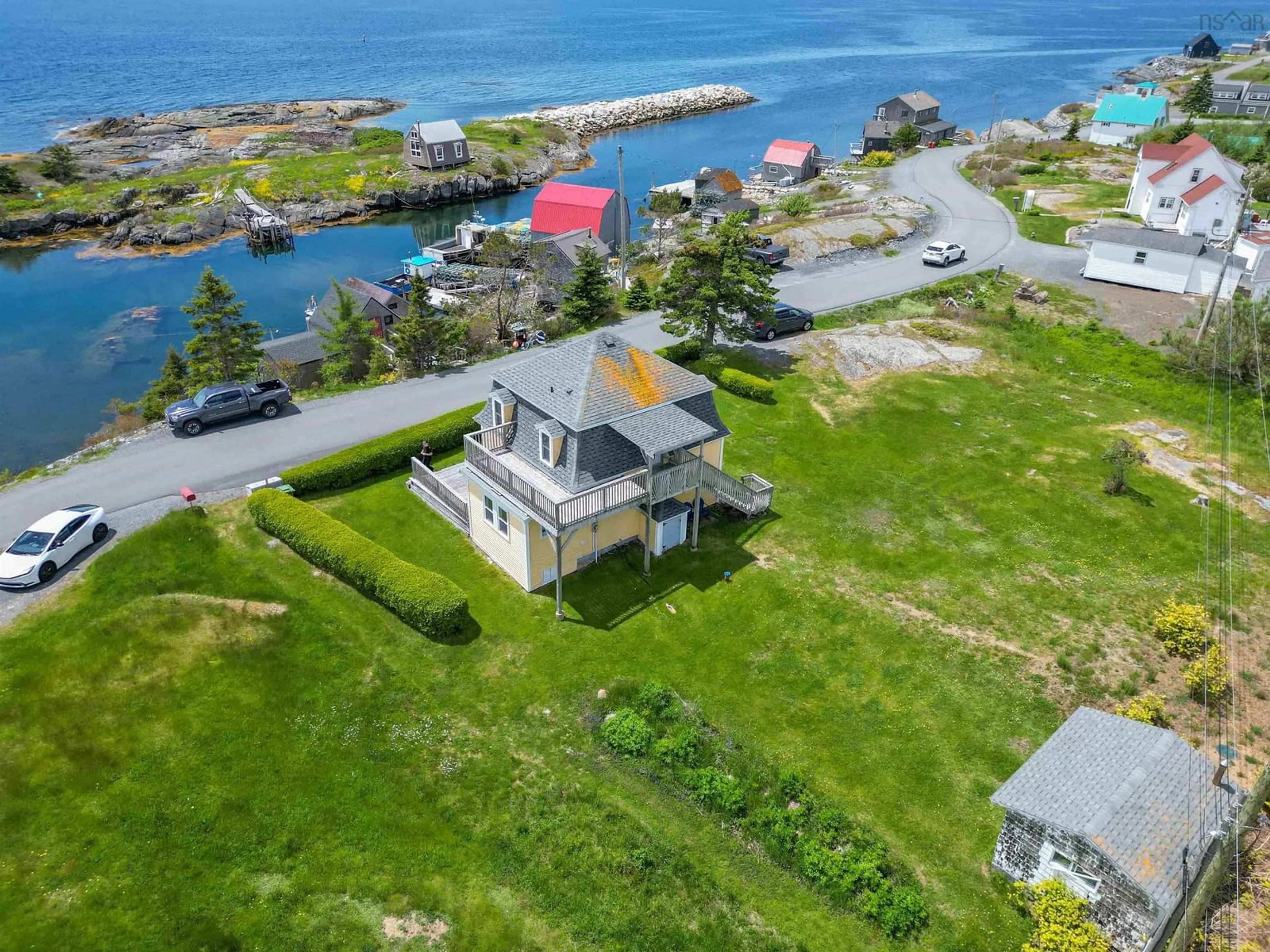 A pic from outside/outdoor area/front of a property/back of a property/a pic from drone, water/lake/river/ocean view for 125 The Point Rd, Blue Rocks Nova Scotia B0J 2C0
