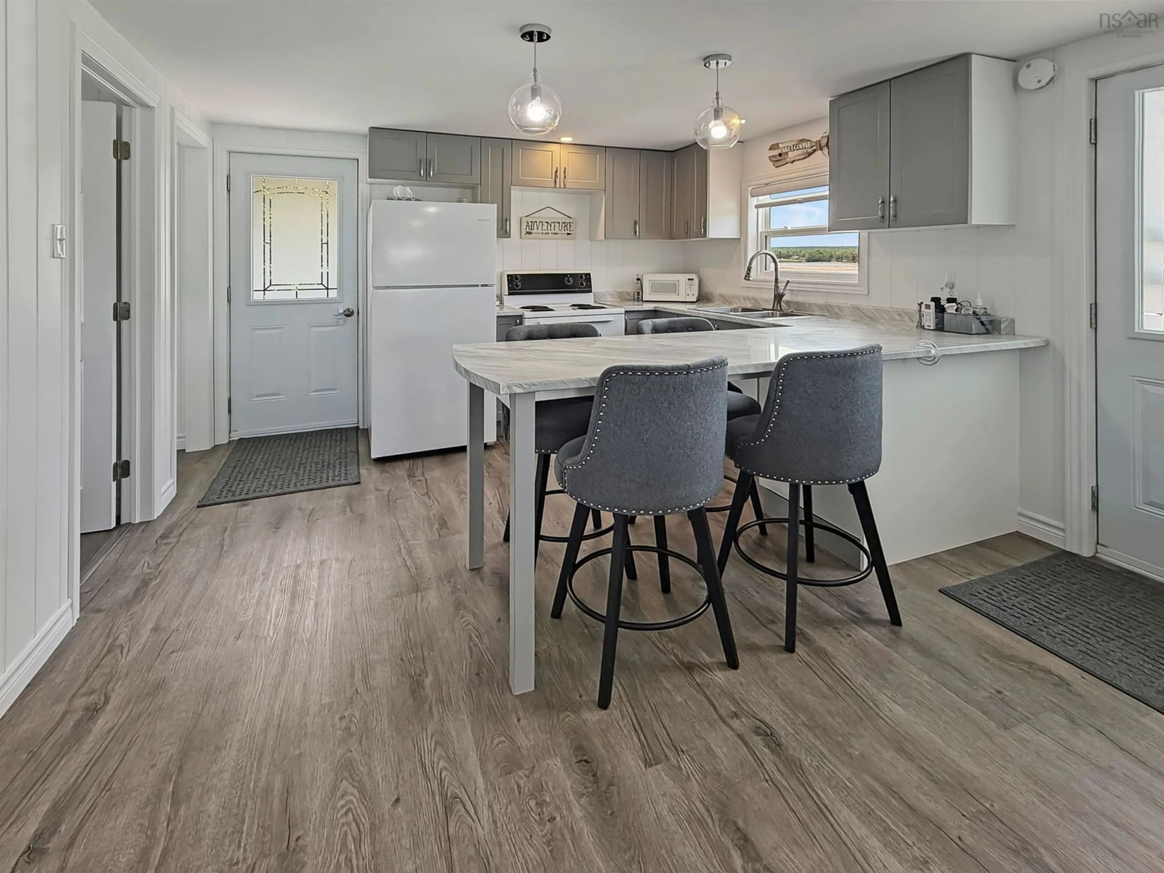 Open concept kitchen, wood/laminate floor for 41 Sand Piper Lane, Black Point Nova Scotia B0K 1X0