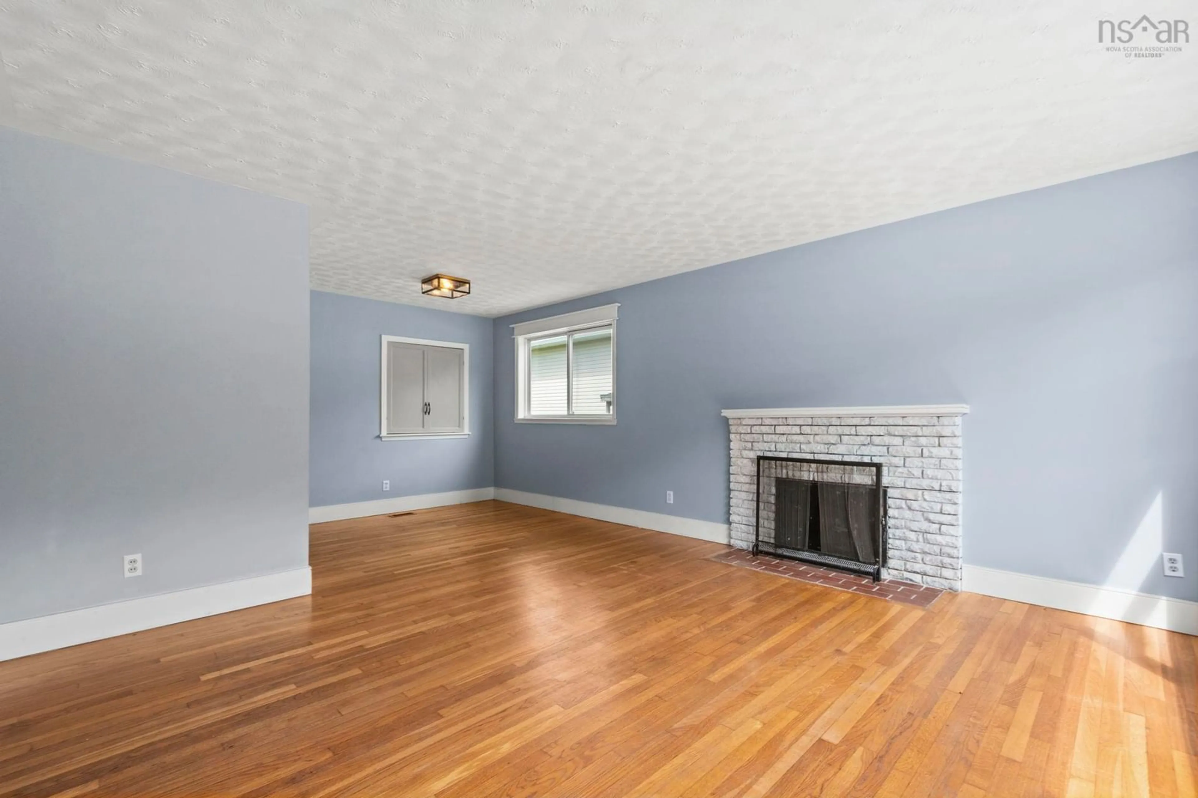 Living room with furniture, wood/laminate floor for 38 Anderson St, Woodlawn Nova Scotia B2W 2V1