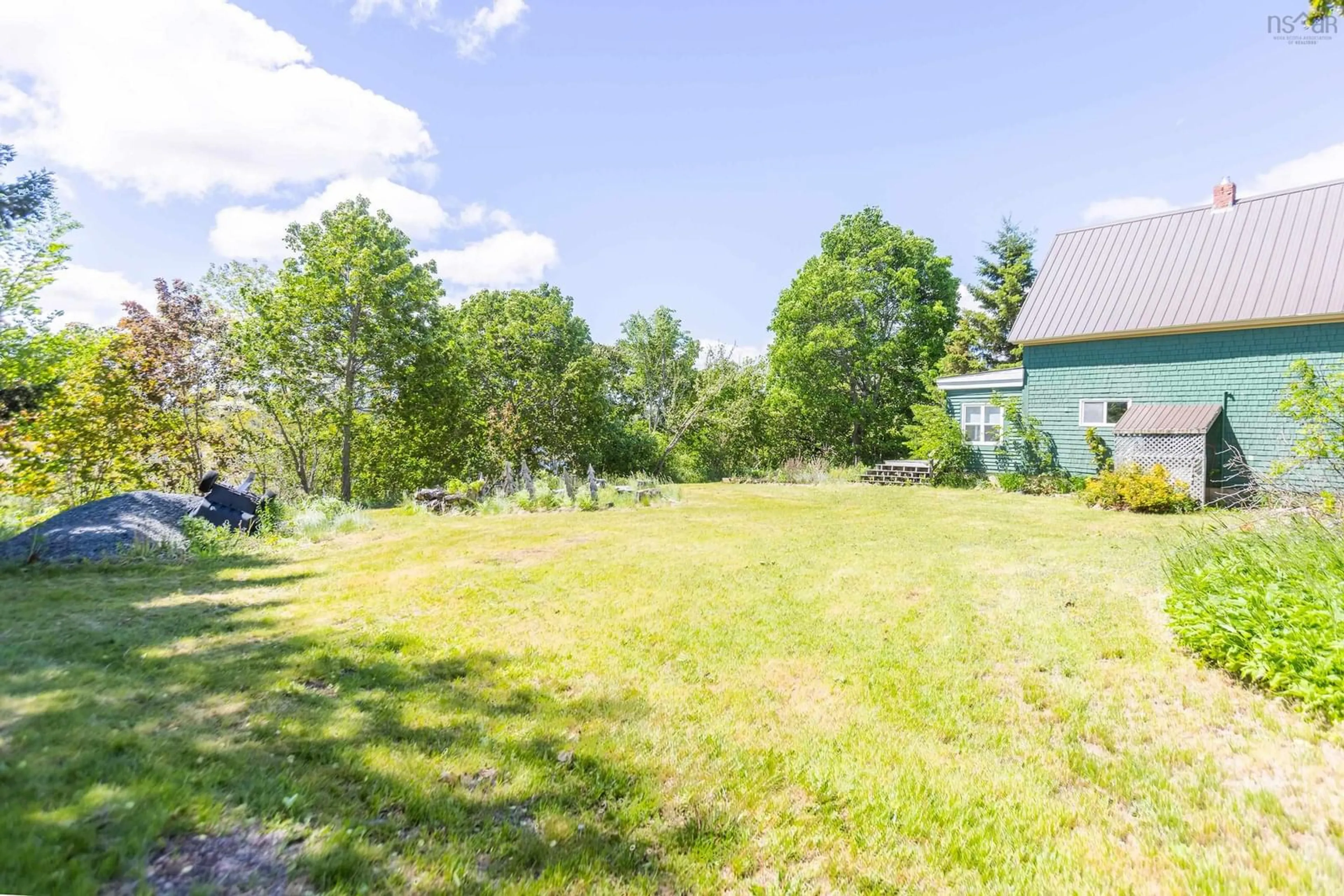 A pic from outside/outdoor area/front of a property/back of a property/a pic from drone, forest/trees view for 1 Moore St, Parrsboro Nova Scotia B0M 1S0