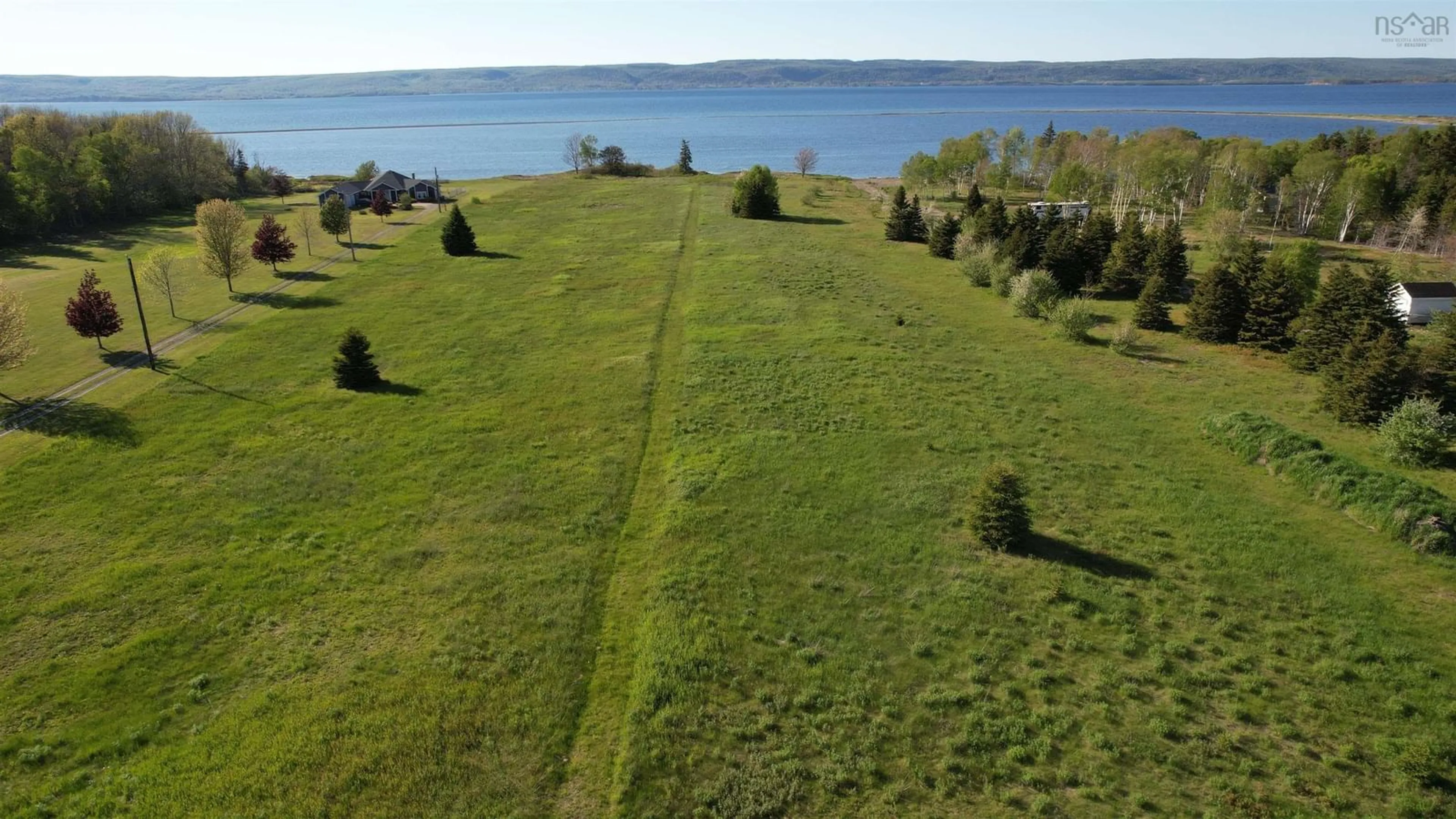 A pic from outside/outdoor area/front of a property/back of a property/a pic from drone, water/lake/river/ocean view for 7903 East Bay Hwy, Big Pond Centre Nova Scotia B1J 1Z3