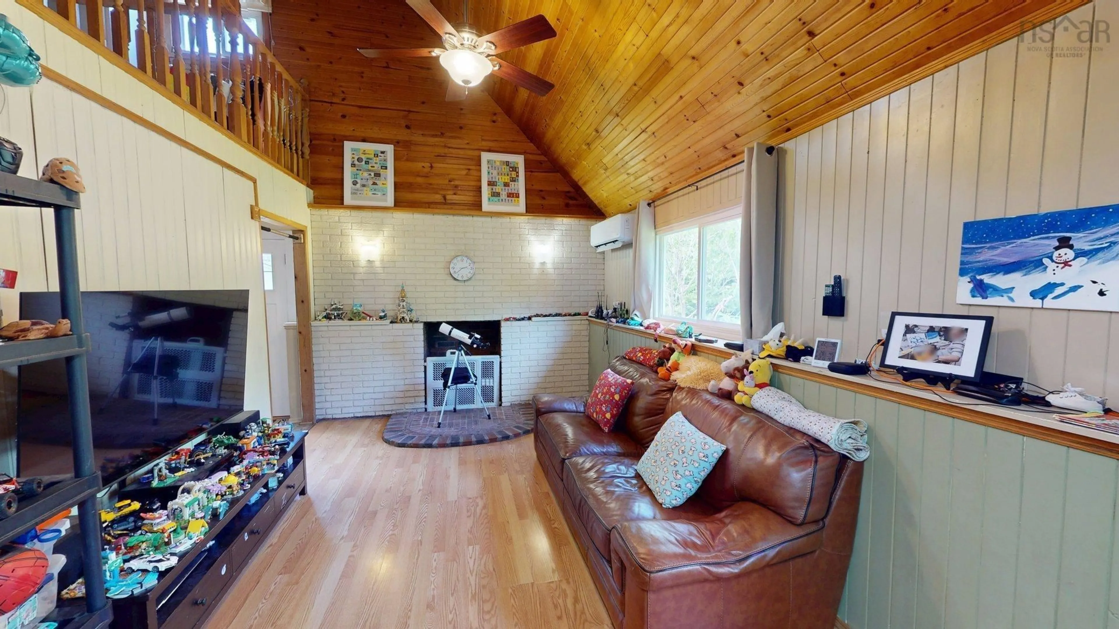 Living room with furniture, wood/laminate floor for 2554 Highway 7 Hwy, East Preston Nova Scotia B2Z 1G6