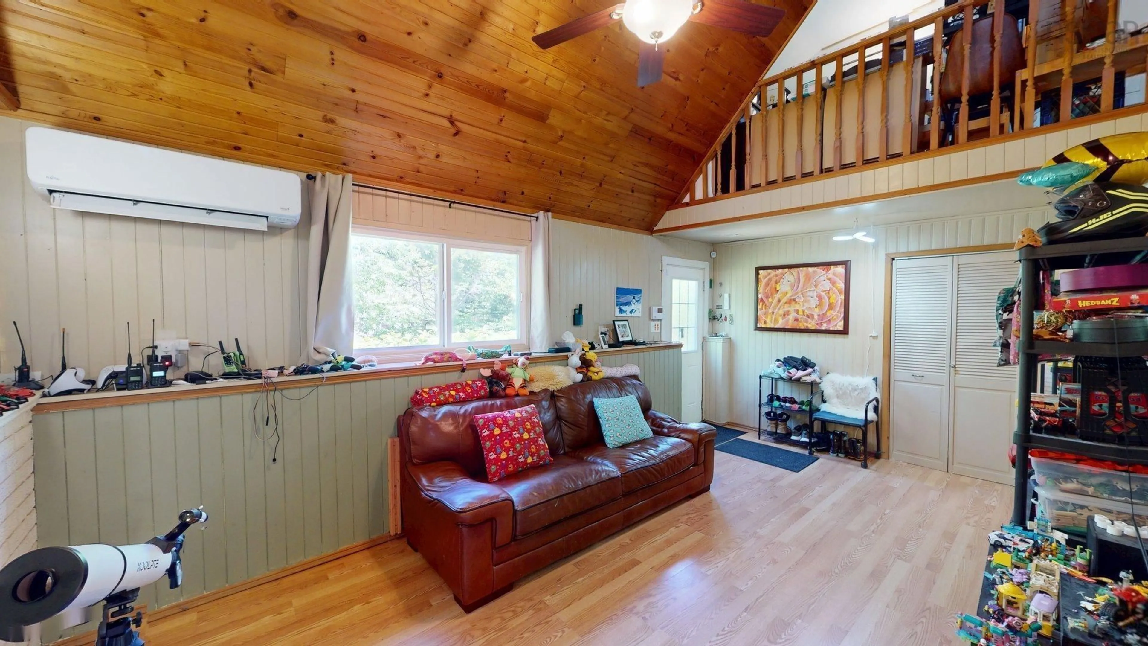 Living room with furniture, wood/laminate floor for 2554 Highway 7 Hwy, East Preston Nova Scotia B2Z 1G6