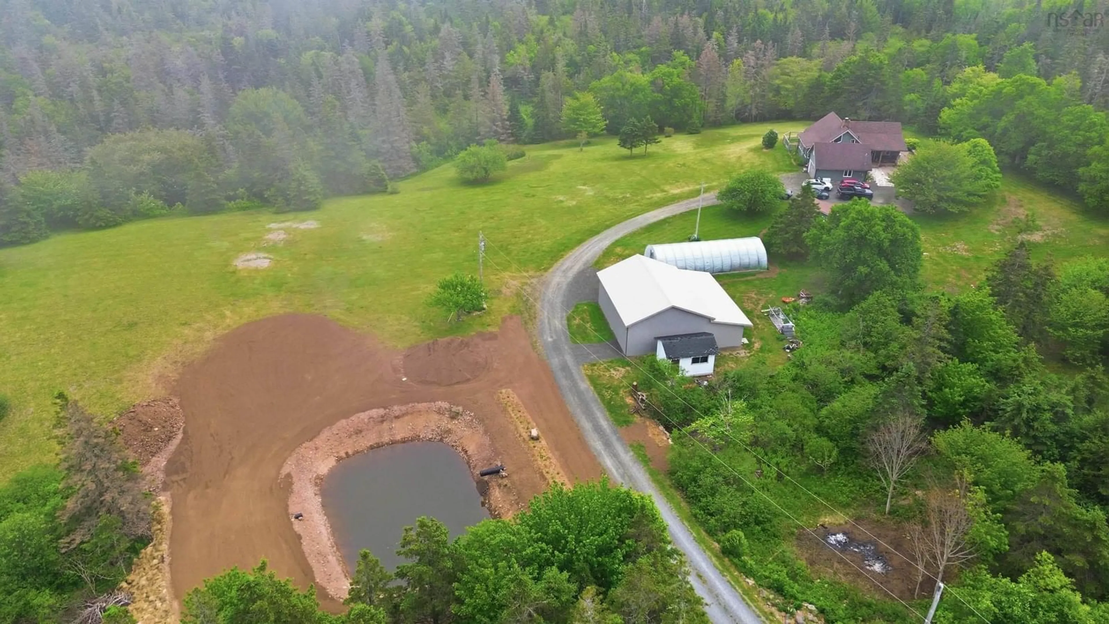 A pic from outside/outdoor area/front of a property/back of a property/a pic from drone, water/lake/river/ocean view for 7130 Highway 217, Lake Midway Nova Scotia B0V 1A0