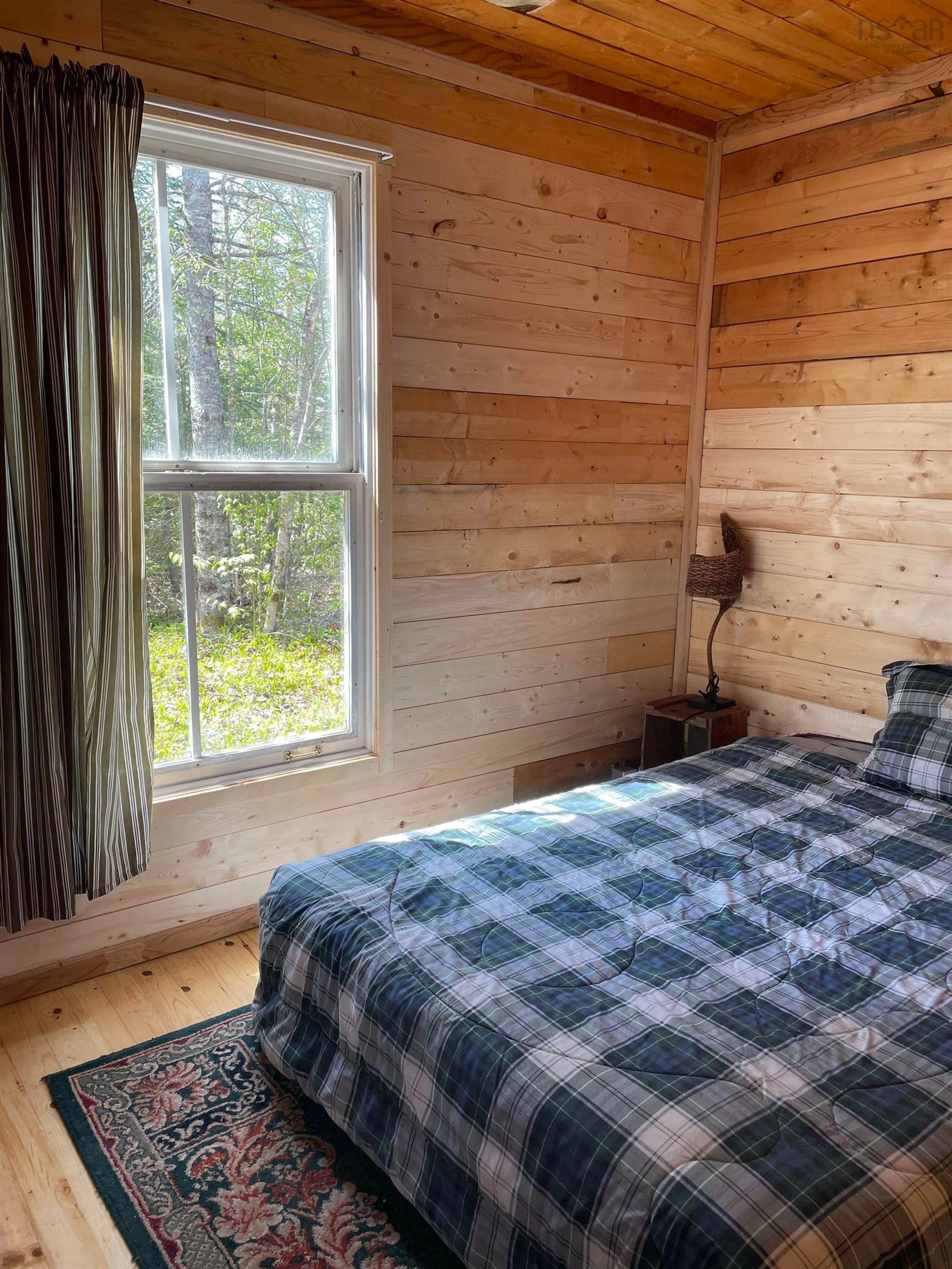 Bedroom with bed, wood/laminate floor for 25 Ton Timber Hills Rd, Moser River Nova Scotia B0J 2R0