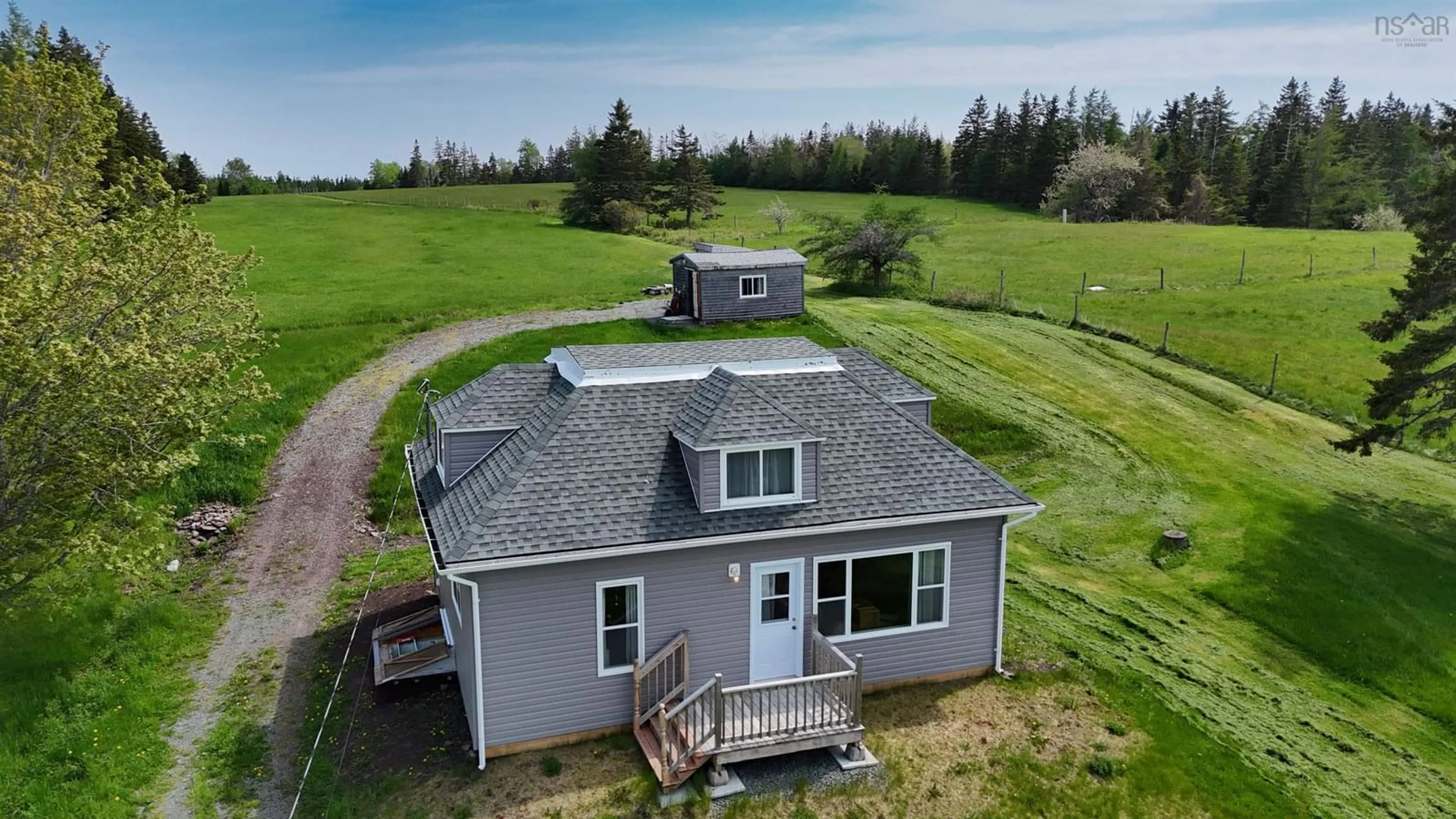 A pic from outside/outdoor area/front of a property/back of a property/a pic from drone, water/lake/river/ocean view for 50 Riverview Dr, River Bourgeois Nova Scotia B0E 2X0
