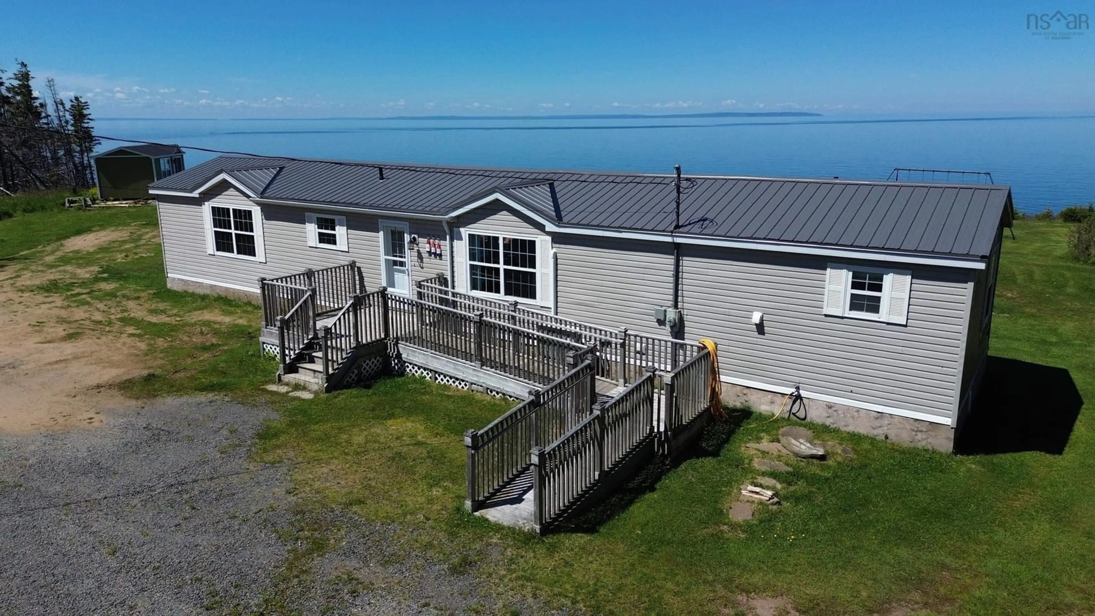 A pic from outside/outdoor area/front of a property/back of a property/a pic from drone, water/lake/river/ocean view for 444 Shore Rd, Harbourview Nova Scotia B0E 2W0