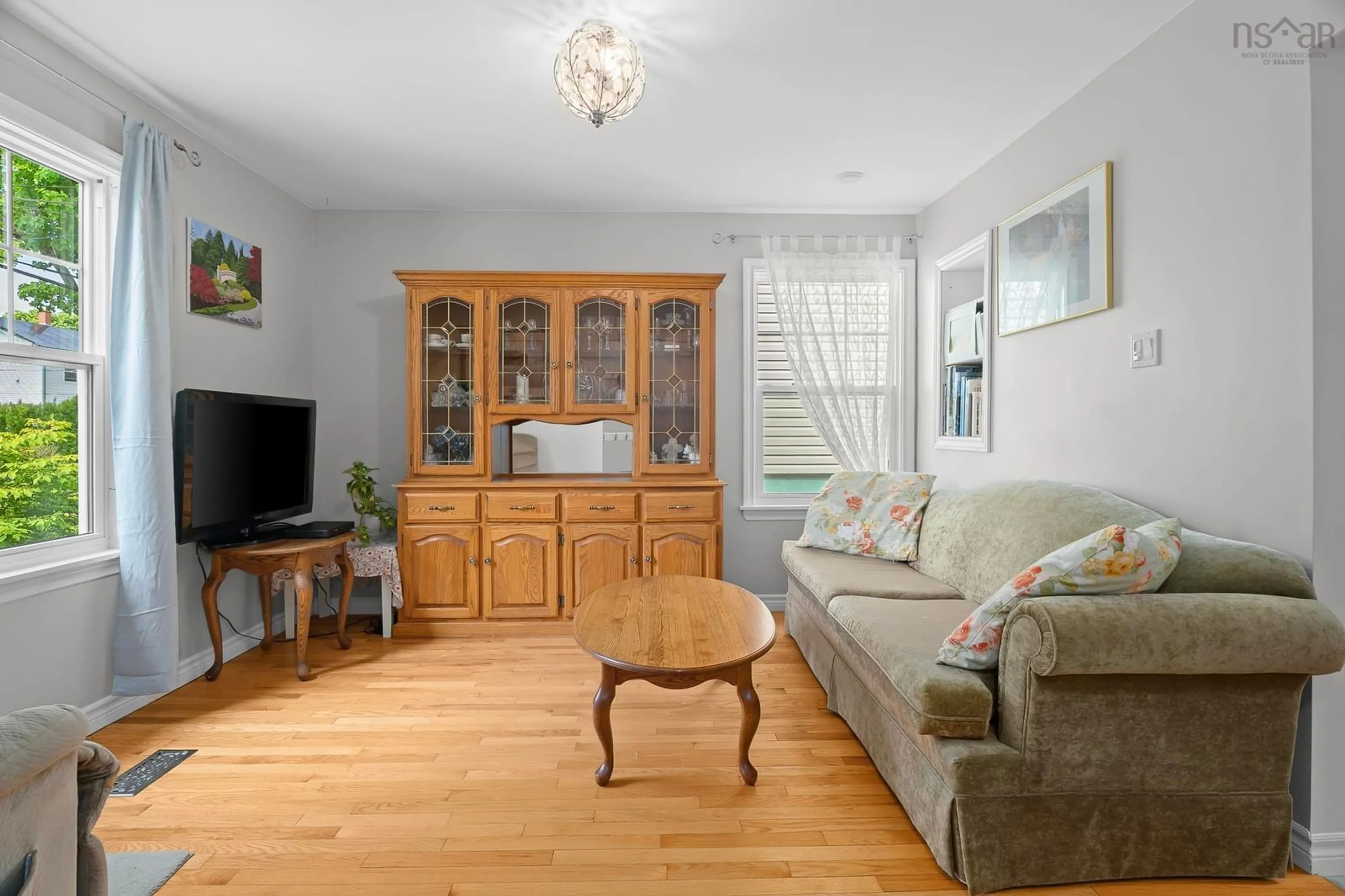 Living room with furniture, wood/laminate floor for 6474 Roslyn Road, Halifax Nova Scotia B3L 2M7