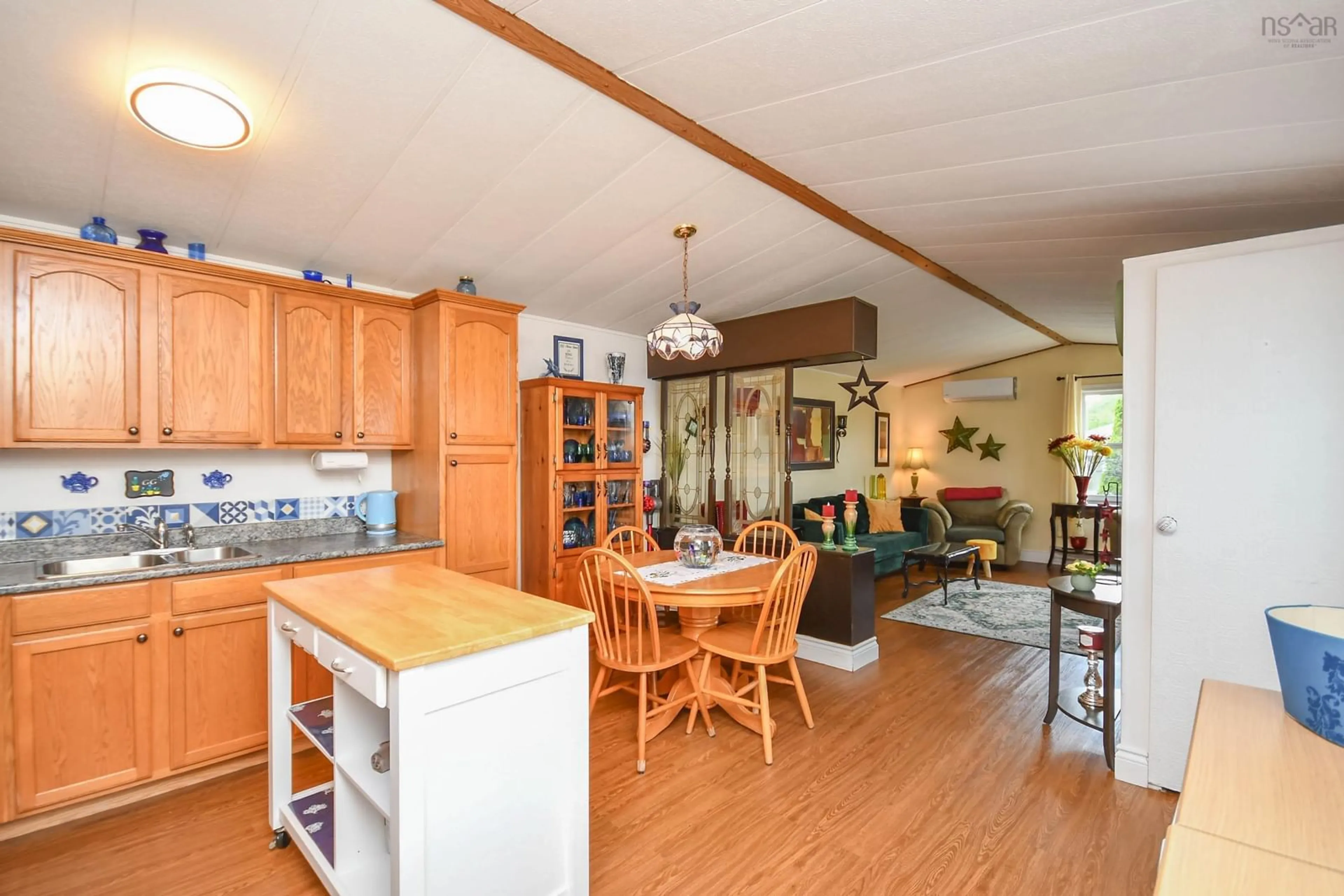 Open concept kitchen, wood/laminate floor for 1526 Woodbine Dr, Beaver Bank Nova Scotia B4E 2M9
