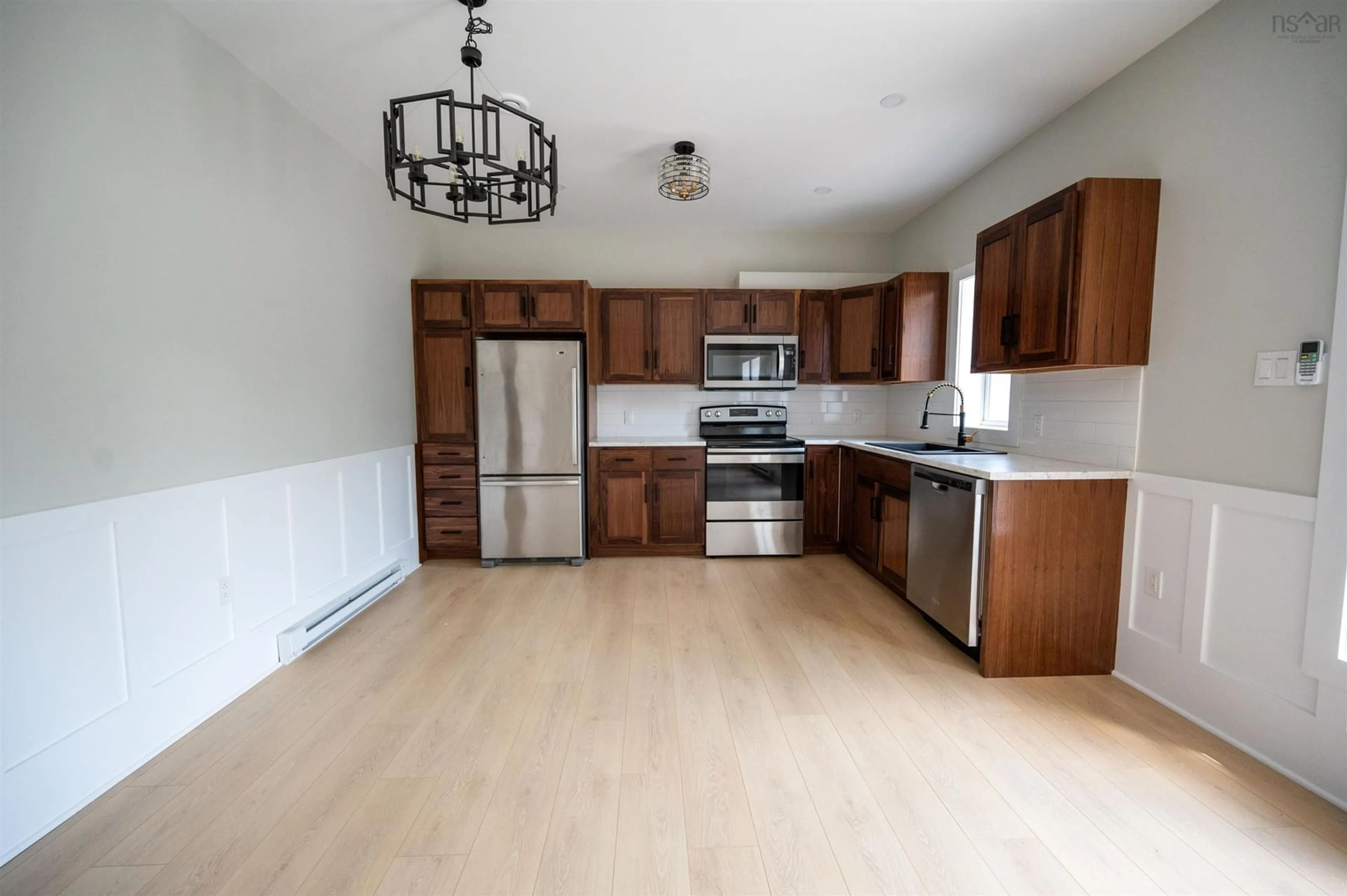 Open concept kitchen, wood/laminate floor for 7,9,11,13 Joel Lane, Chéticamp Nova Scotia B0E 1H0