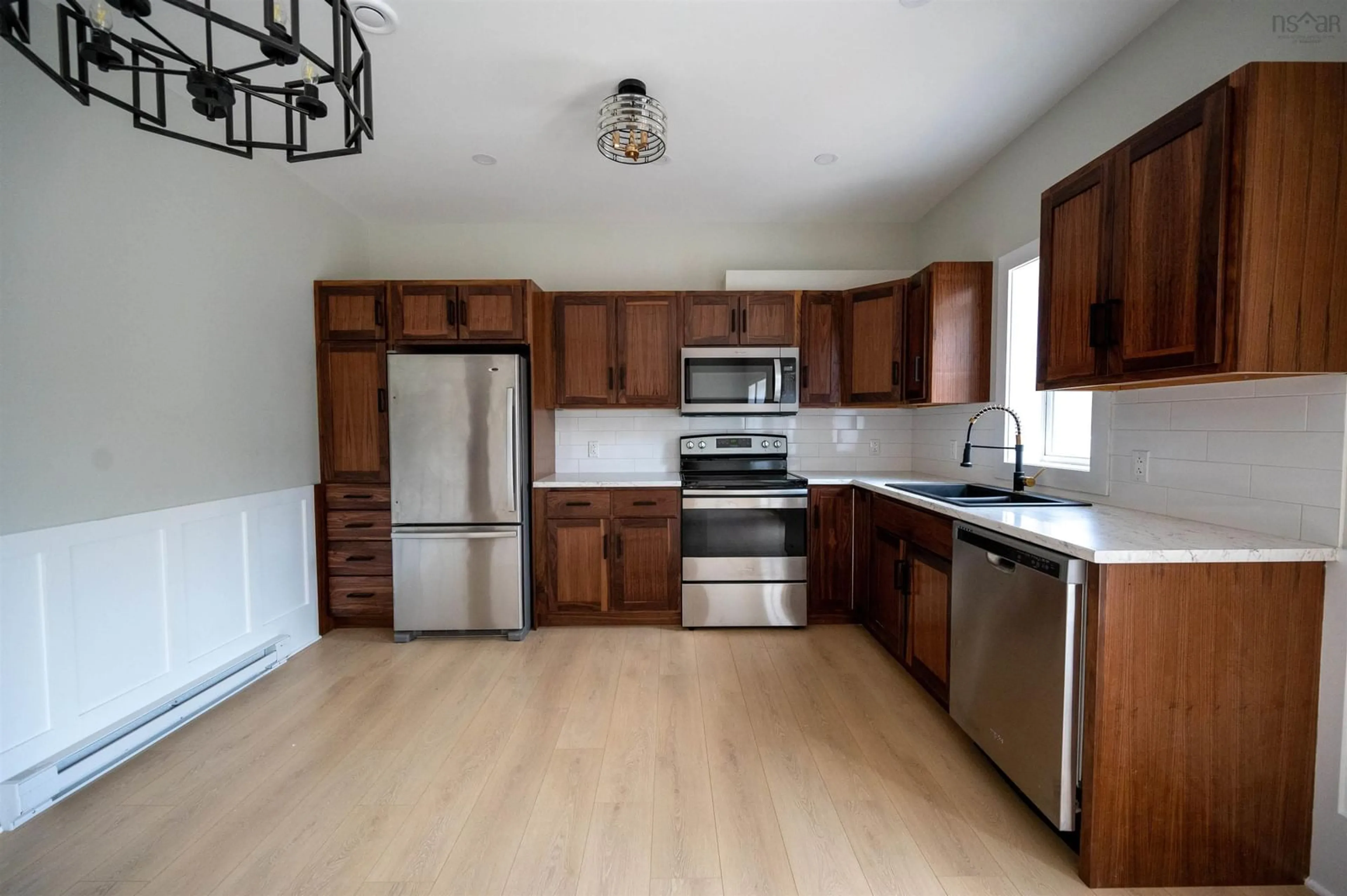 Open concept kitchen, wood/laminate floor for 7,9,11,13 Joel Lane, Chéticamp Nova Scotia B0E 1H0