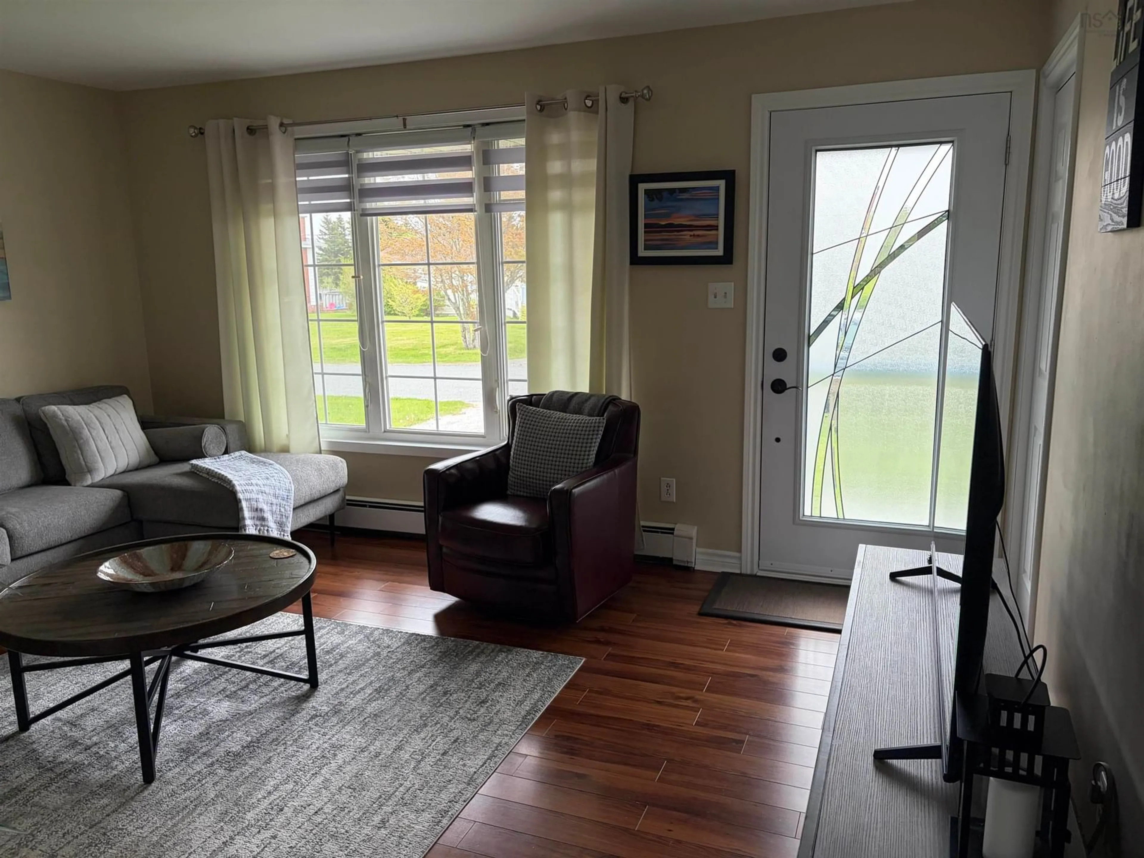 Living room with furniture, wood/laminate floor for 14 Drew St, Glace Bay Nova Scotia B1A 1A7