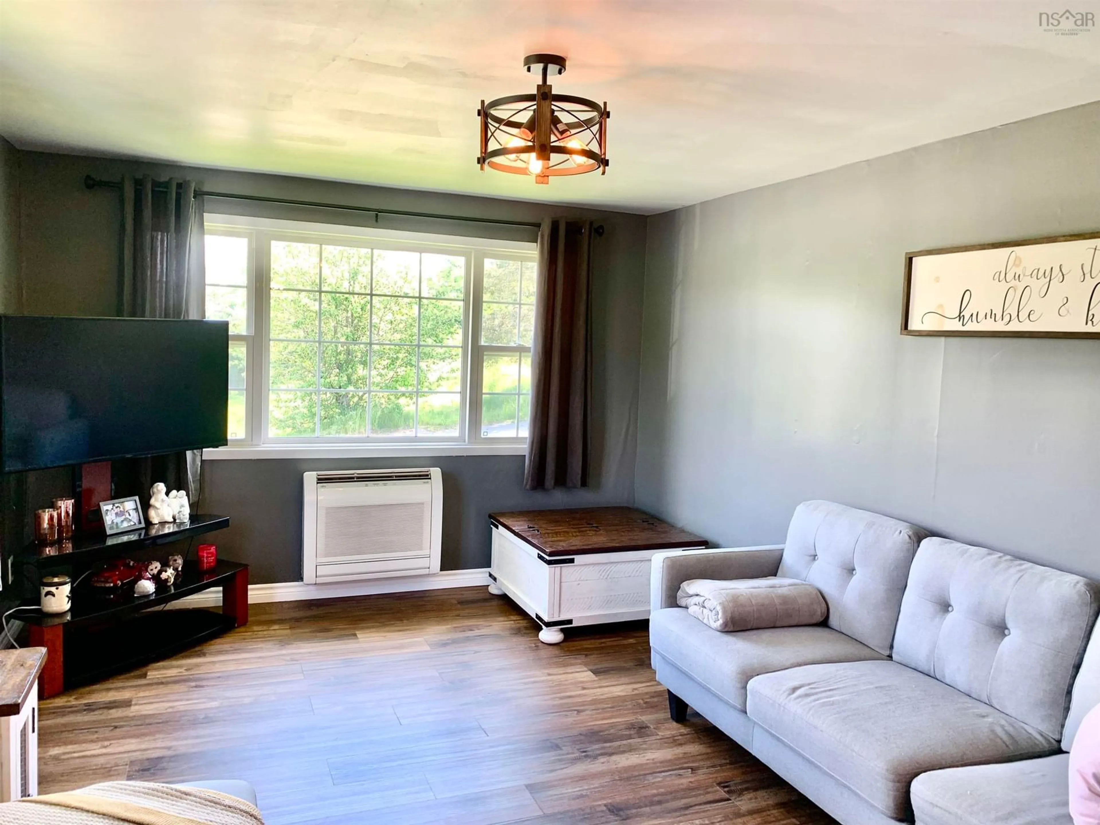 Living room with furniture, wood/laminate floor for 82 Wolsley St, Springhill Nova Scotia B0M 1X0