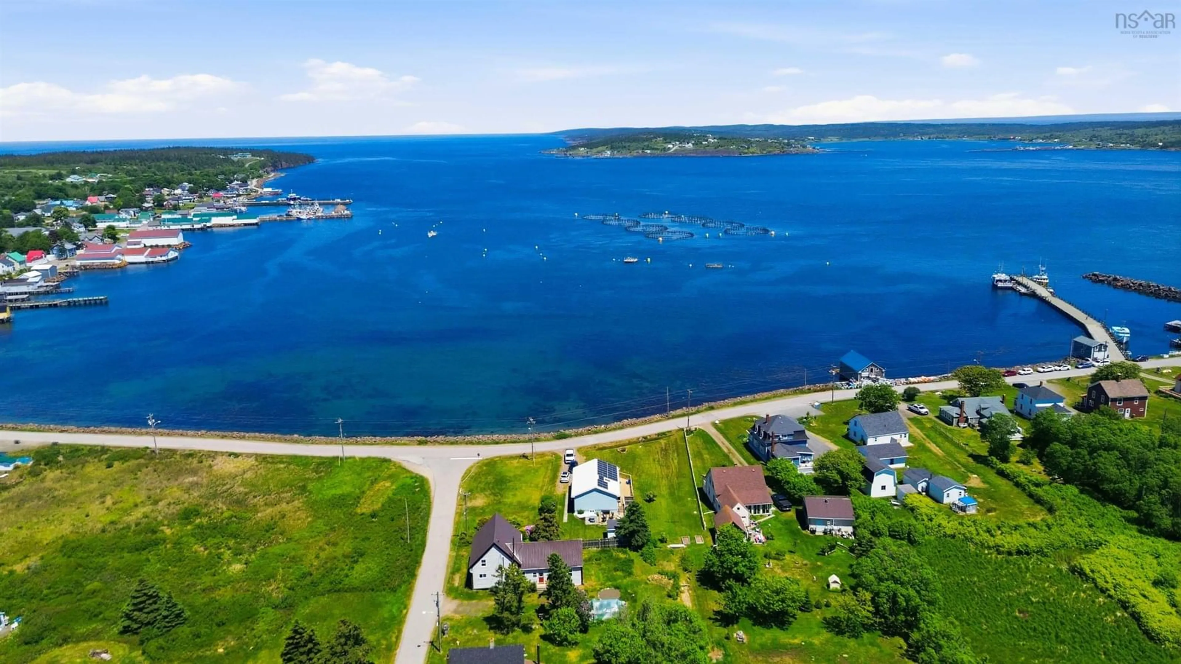 A pic from outside/outdoor area/front of a property/back of a property/a pic from drone, water/lake/river/ocean view for 161 Water St, Westport Nova Scotia B0V 1H0