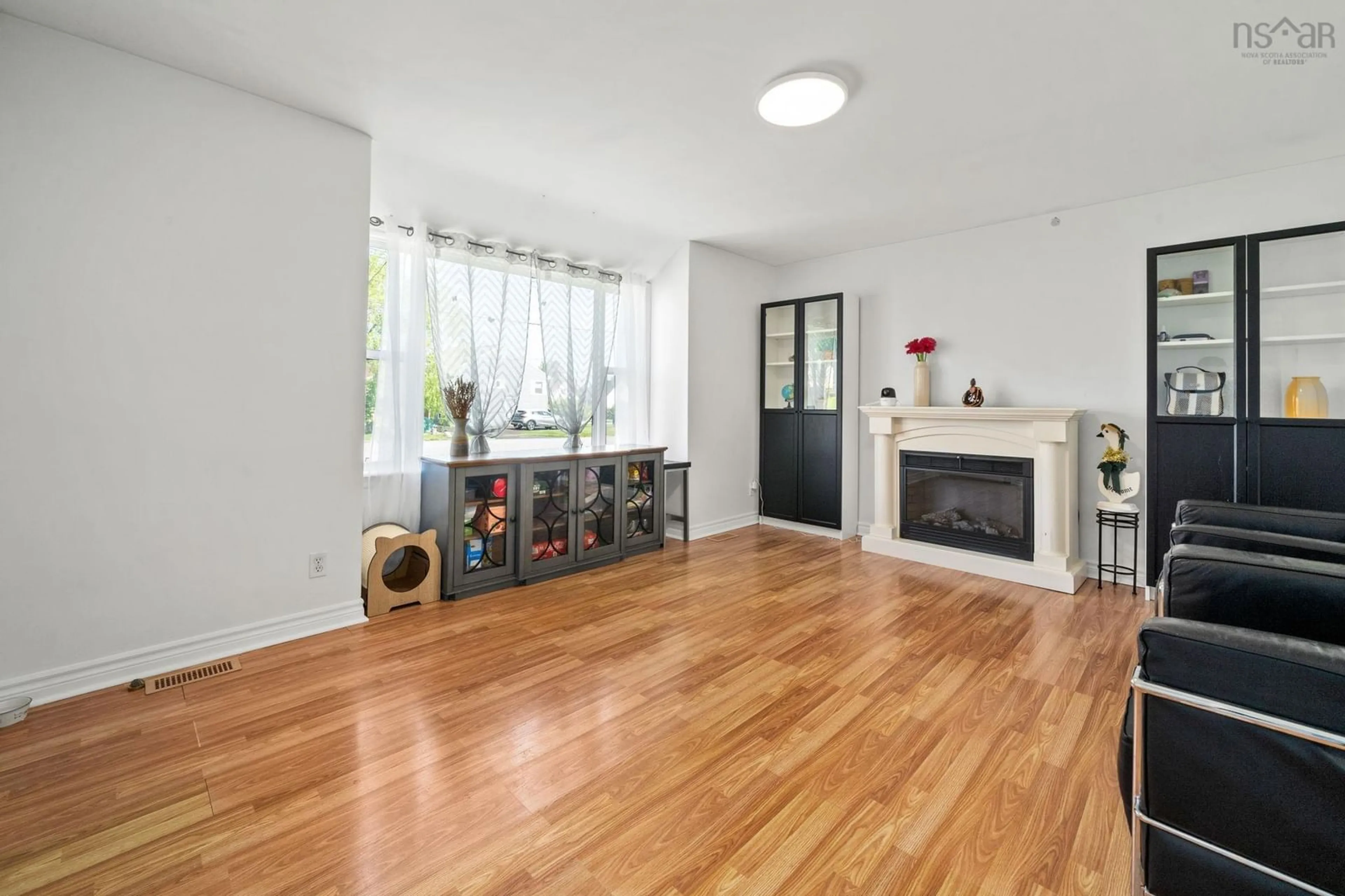 Living room with furniture, wood/laminate floor for 18 Avon Crescent, Spryfield Nova Scotia B3R 2E3