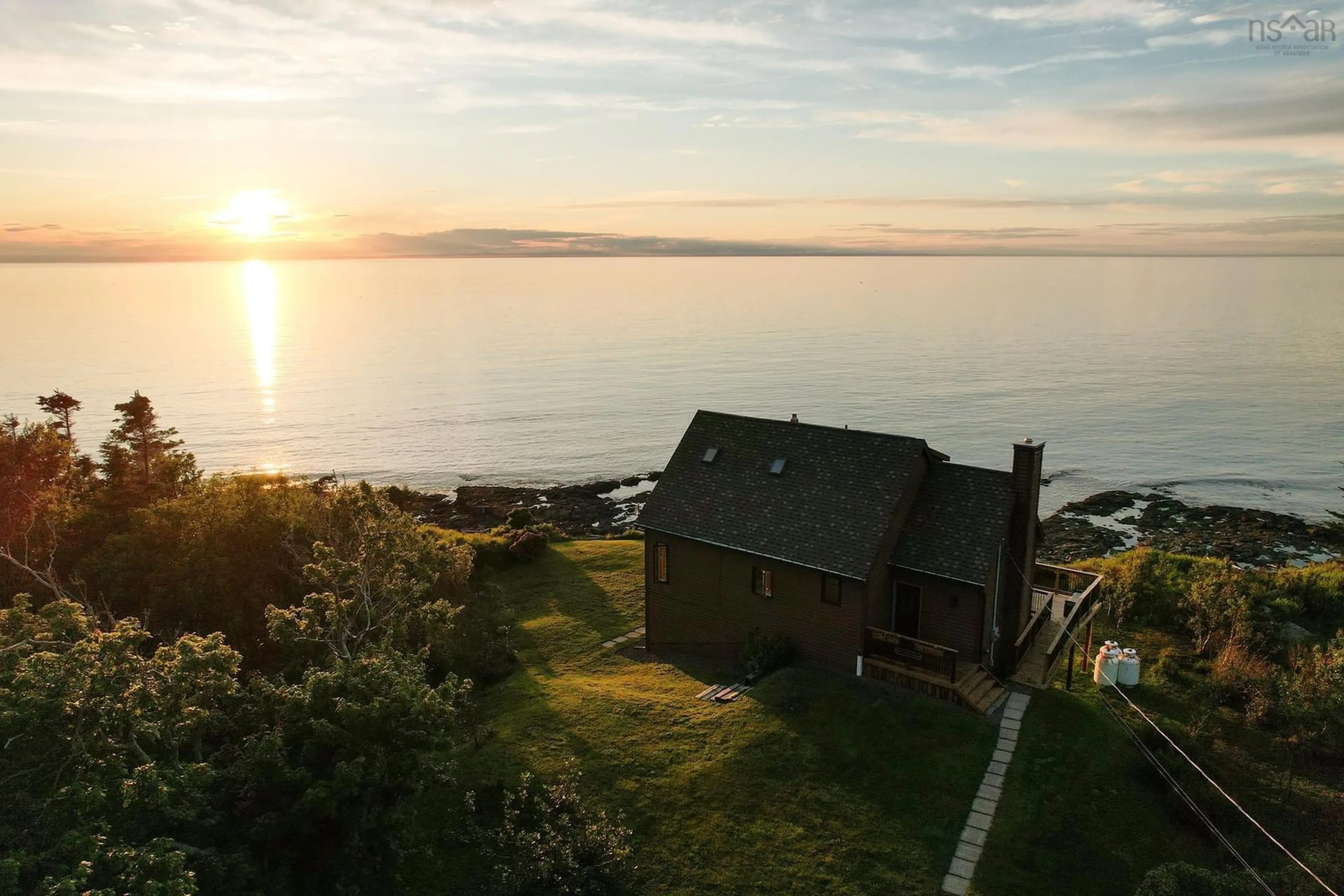 A pic from outside/outdoor area/front of a property/back of a property/a pic from drone, water/lake/river/ocean view for 6671 Shore Rd, Youngs Cove Nova Scotia B0S 1L0