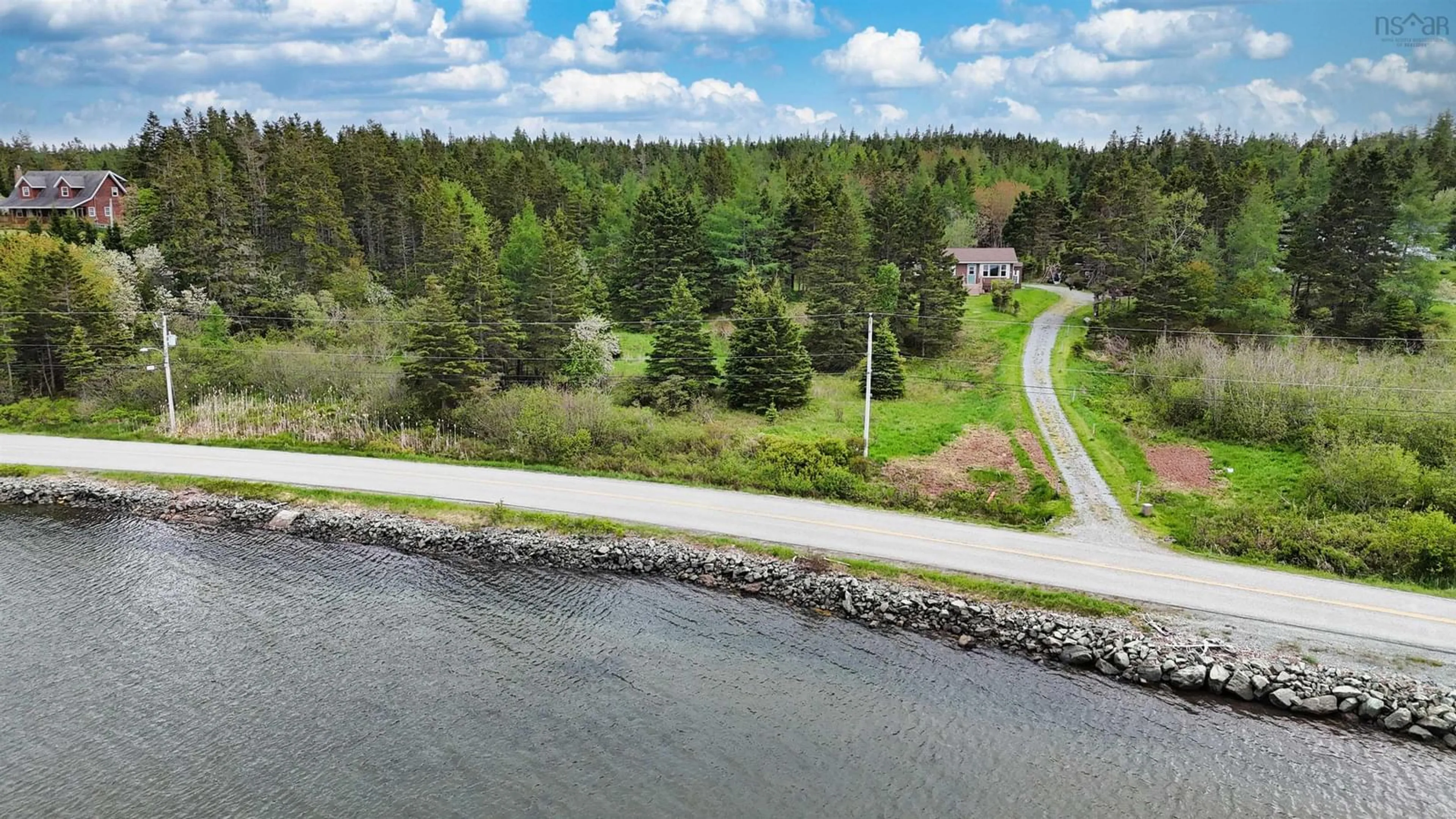 A pic from outside/outdoor area/front of a property/back of a property/a pic from drone, water/lake/river/ocean view for 84 South Side River Bourgeois Rd, River Bourgeois Nova Scotia B0E 2X0