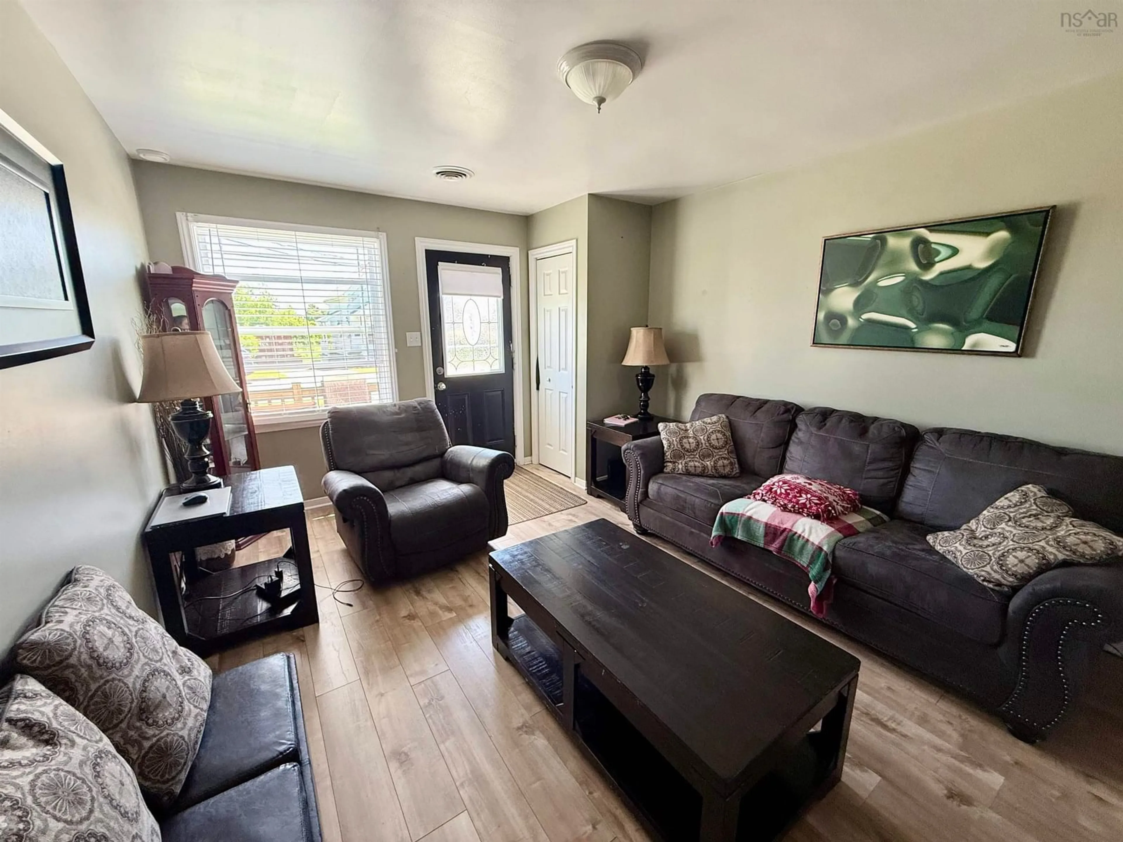 Living room with furniture, wood/laminate floor for 21 Catherine St, Whitney Pier Nova Scotia B1N 2W2