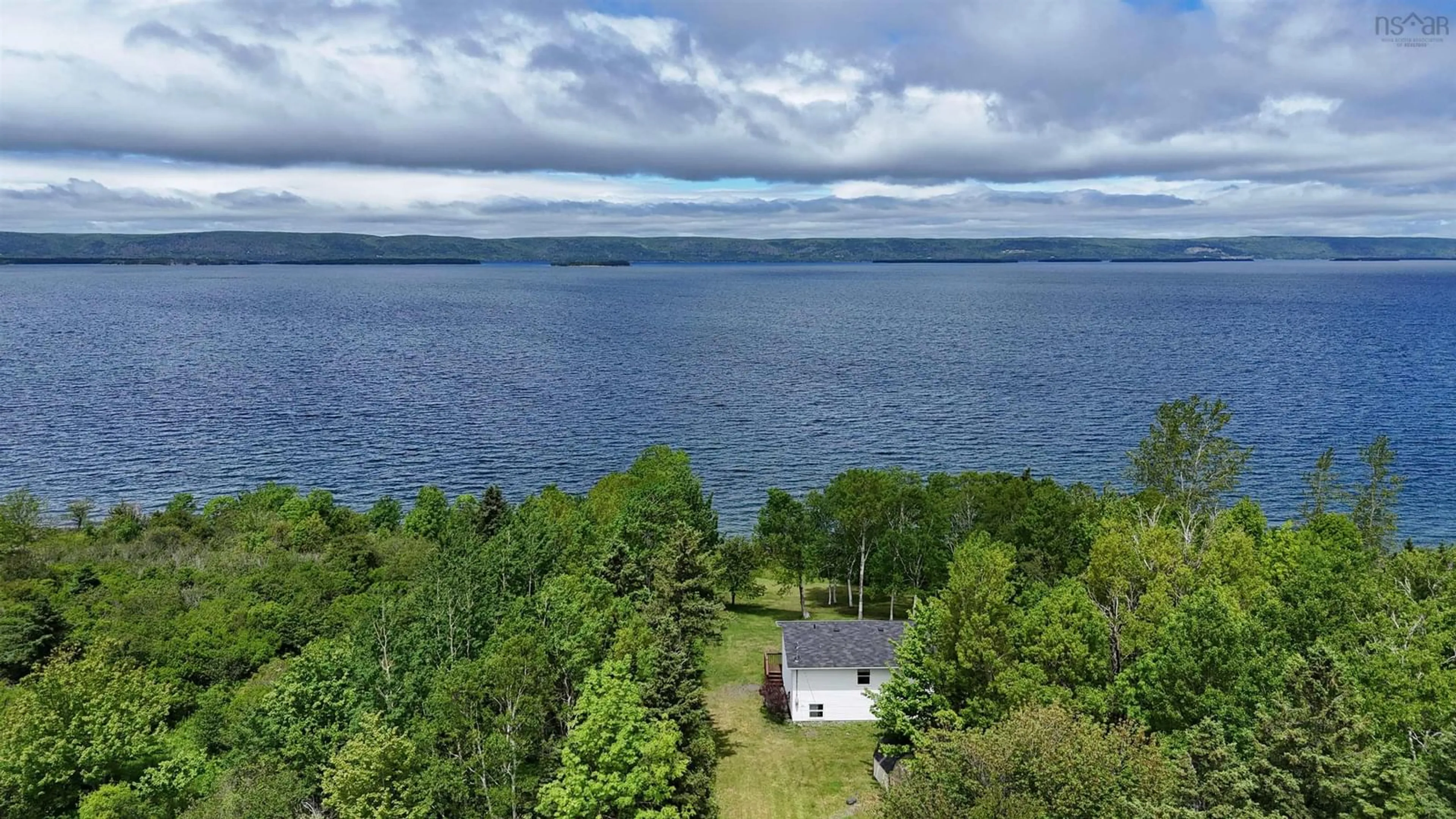 A pic from outside/outdoor area/front of a property/back of a property/a pic from drone, water/lake/river/ocean view for 3653 West Bay Road, St. Georges Channel Nova Scotia B0E 3K0