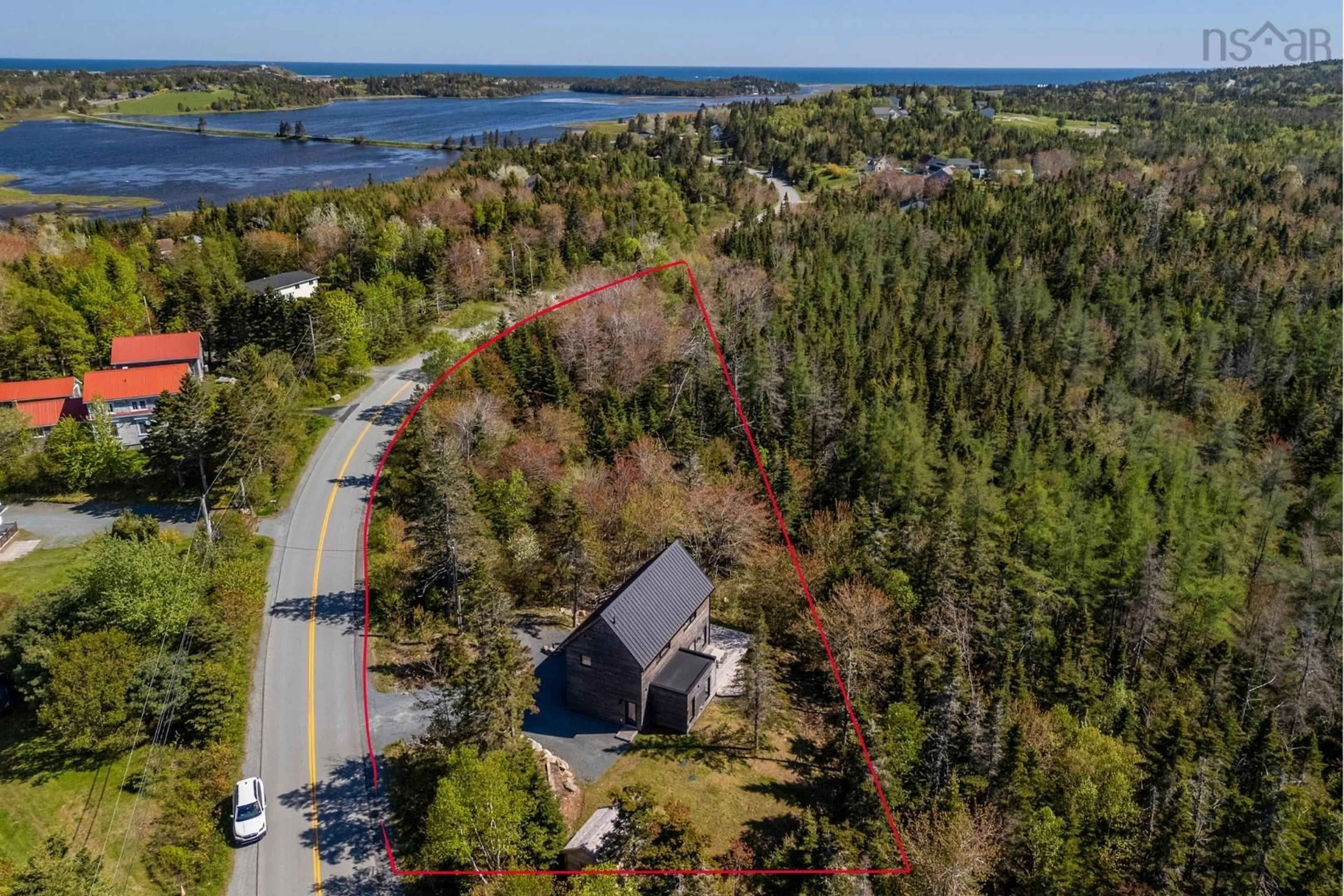 A pic from outside/outdoor area/front of a property/back of a property/a pic from drone, water/lake/river/ocean view for 5 West Lawrencetown Rd, Lawrencetown Nova Scotia B2Z 1S4