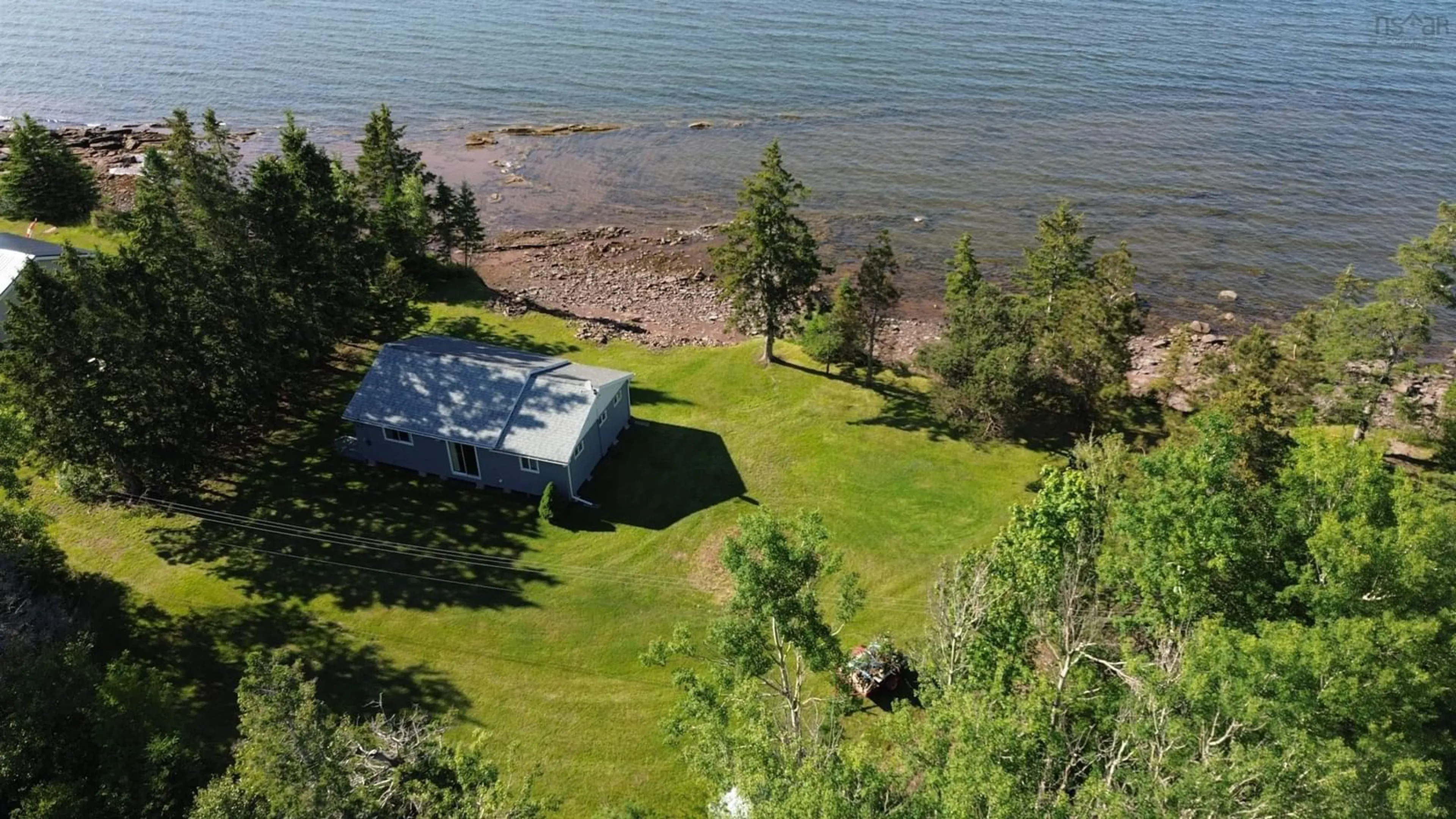 A pic from outside/outdoor area/front of a property/back of a property/a pic from drone, water/lake/river/ocean view for 99 Purdy Beach Lane, Pugwash Nova Scotia B0K 1L0