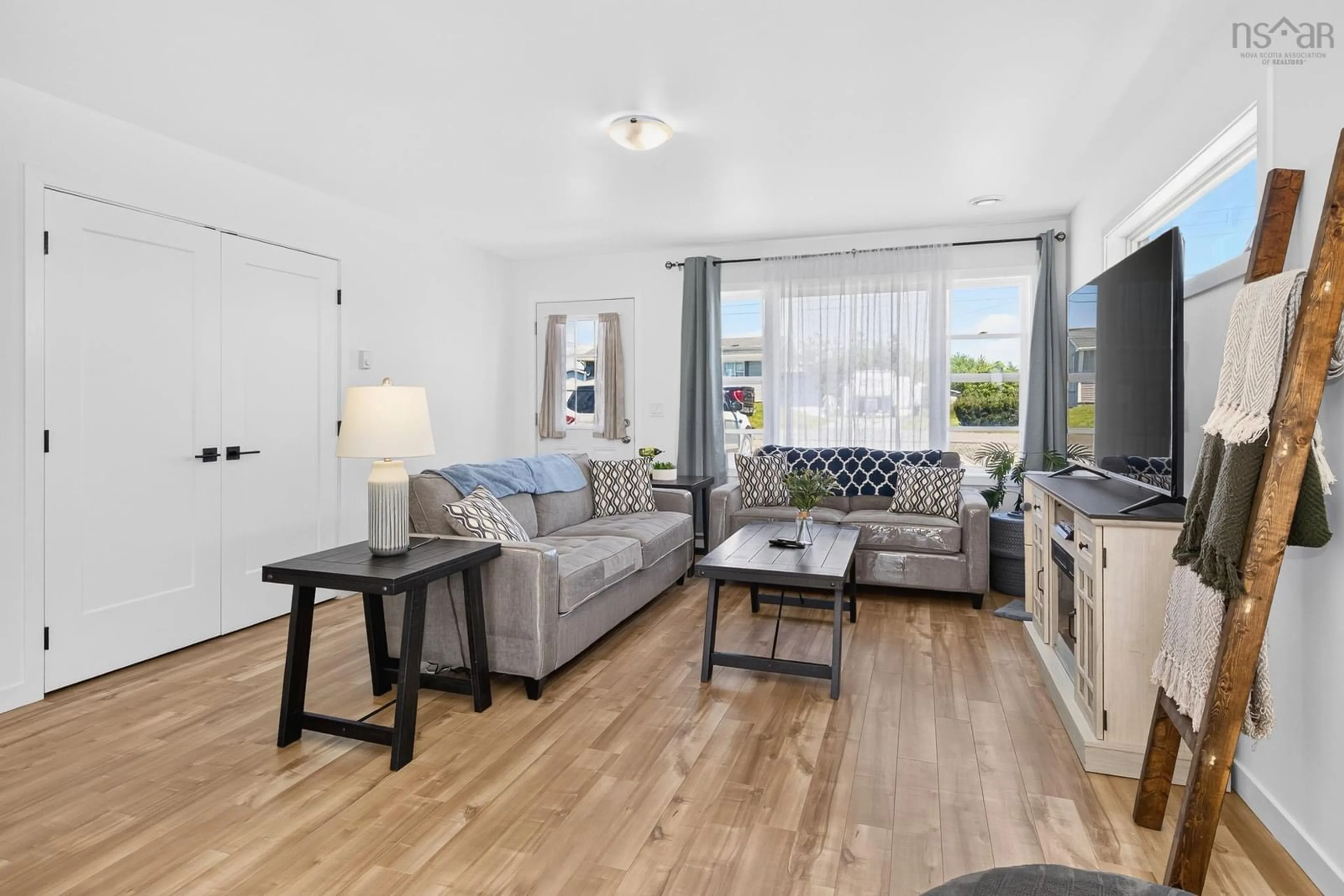 Living room with furniture, wood/laminate floor for 33/35 Maple St, Scotchtown Nova Scotia B1H 3M4