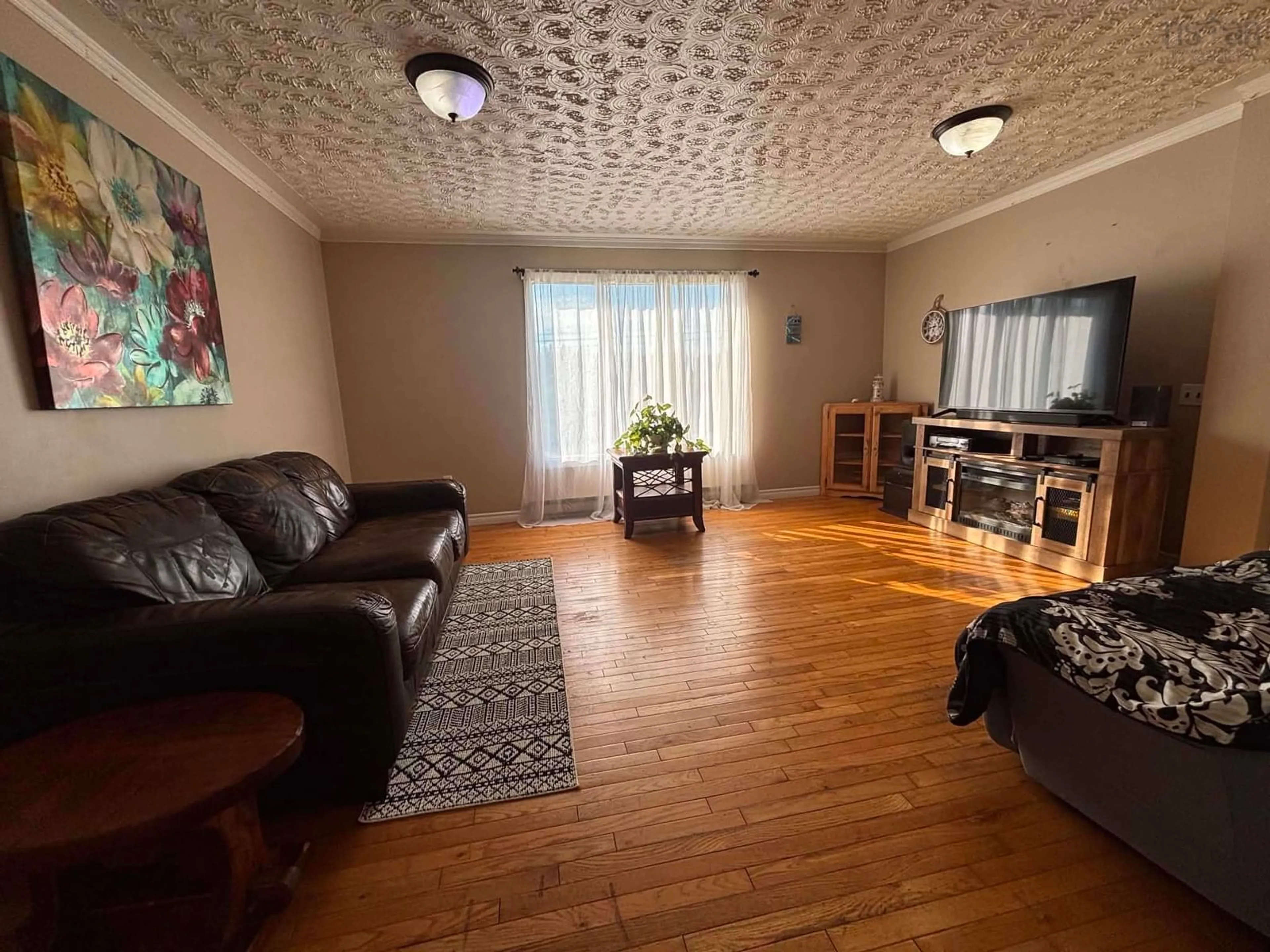 Living room with furniture, wood/laminate floor for 32 Chemin Herb Leblanc Rd, Salmon River Nova Scotia B0W 2Y0