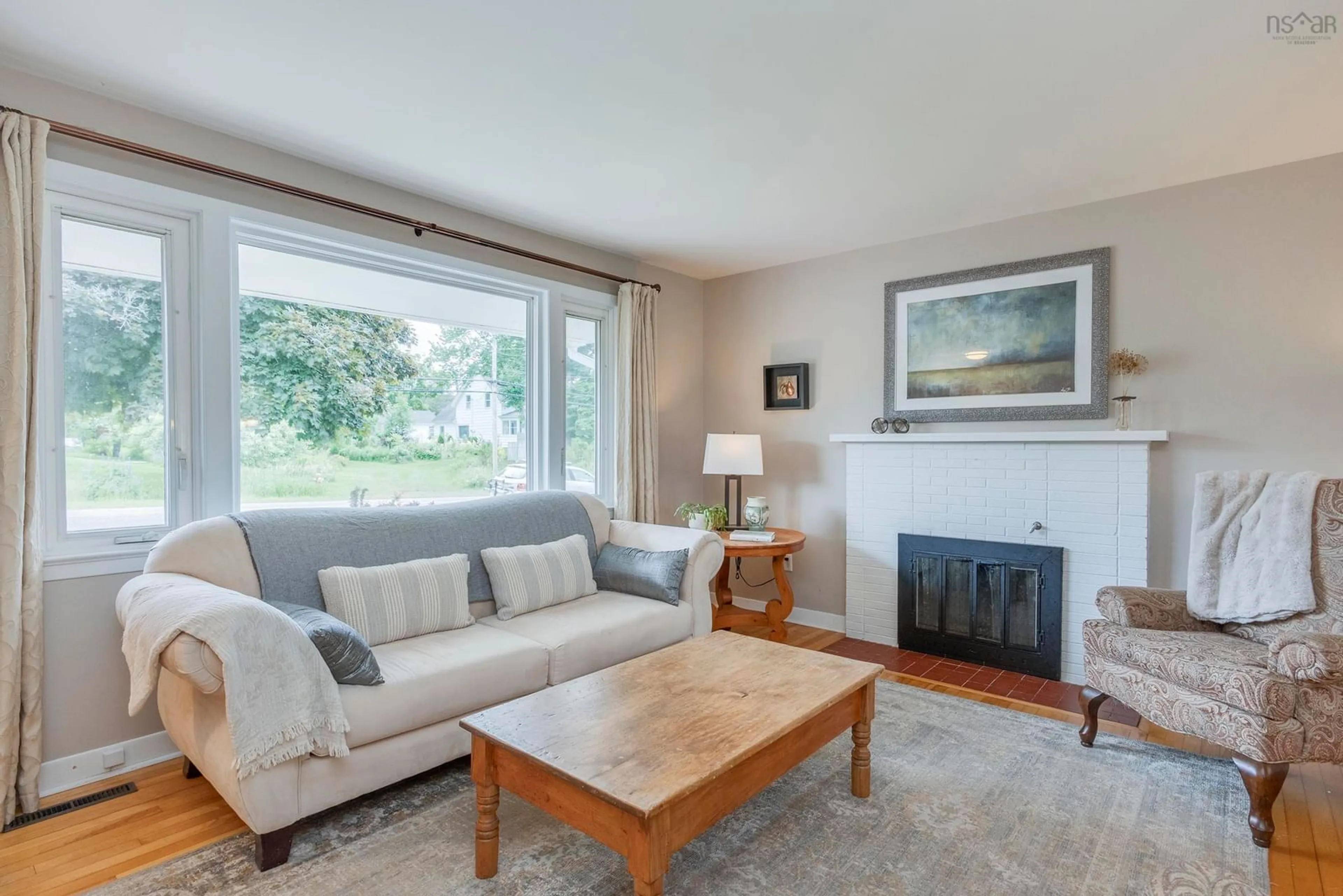 Living room with furniture, wood/laminate floor for 2261 North Ave, Canning Nova Scotia B0P 1H0