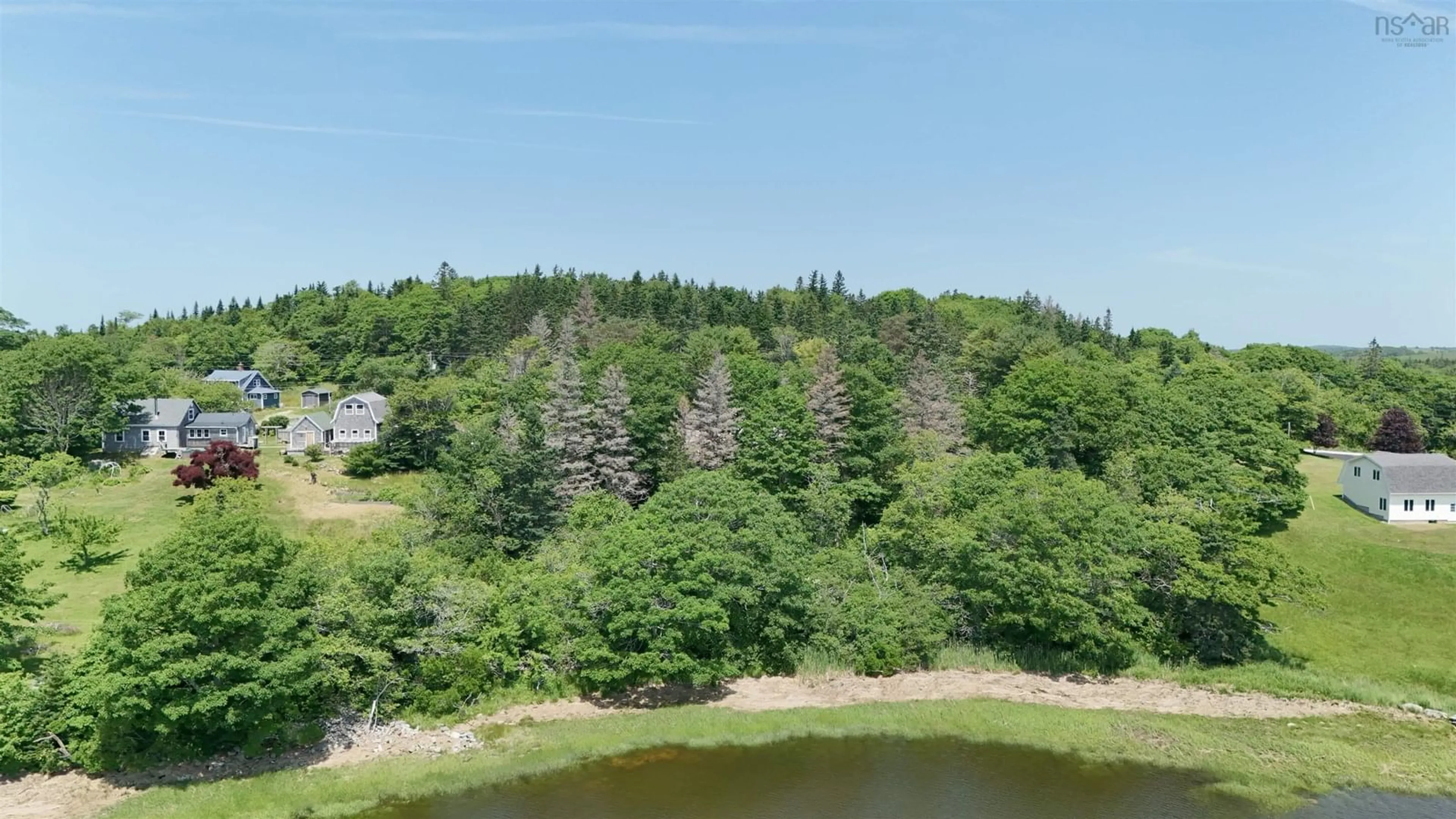 A pic from outside/outdoor area/front of a property/back of a property/a pic from drone, water/lake/river/ocean view for 5881 Highway 3, Glenwood Nova Scotia B0W 1W0
